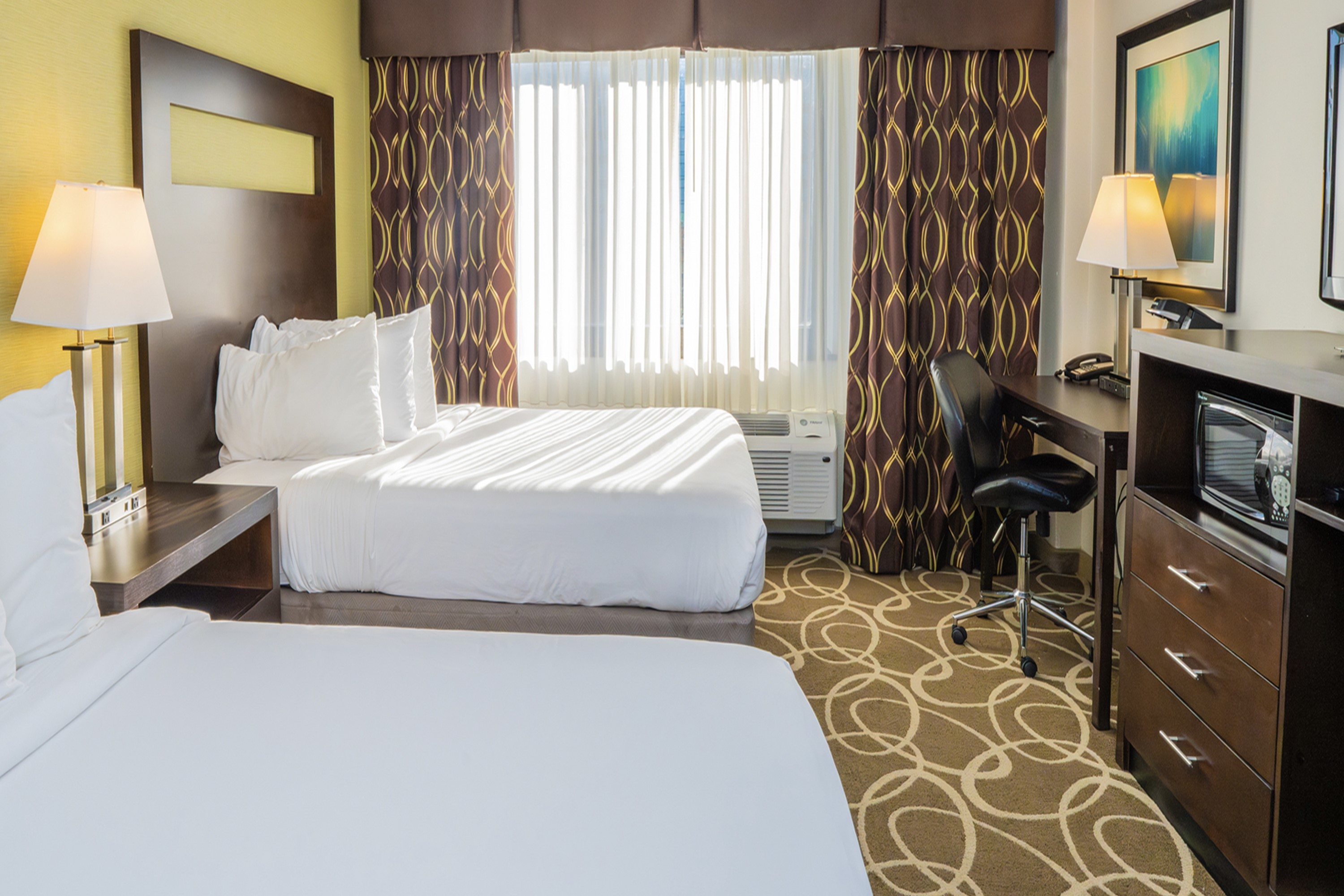 Guest room at the Elimwood Hotel, a Ramada by Wyndham in Maryland Heights, Missouri