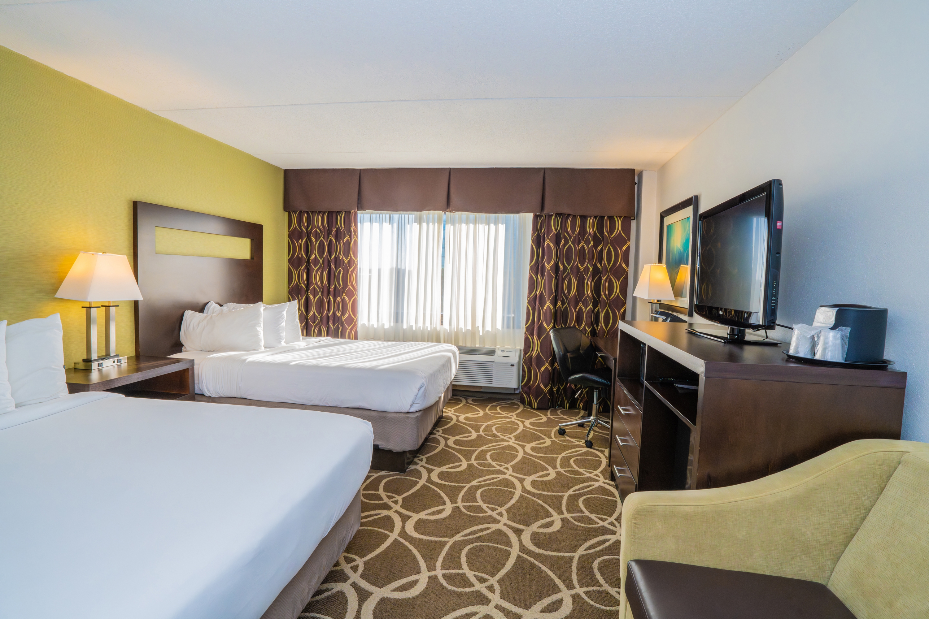 Guest room at the Elimwood Hotel, a Ramada by Wyndham in Maryland Heights, Missouri