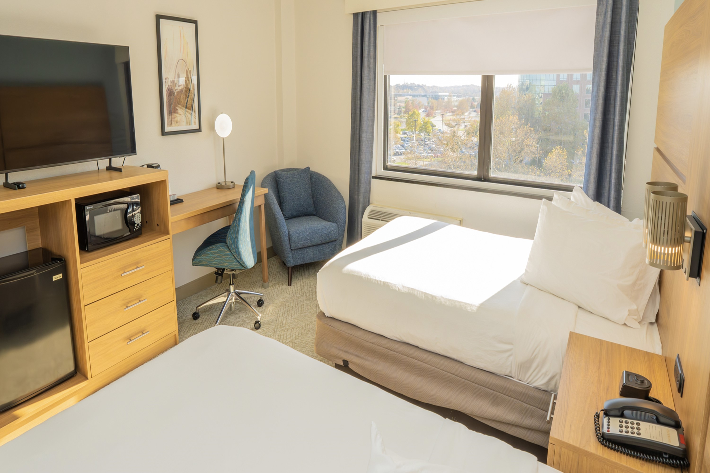Guest room at the Elimwood Hotel, a Ramada by Wyndham in Maryland Heights, Missouri