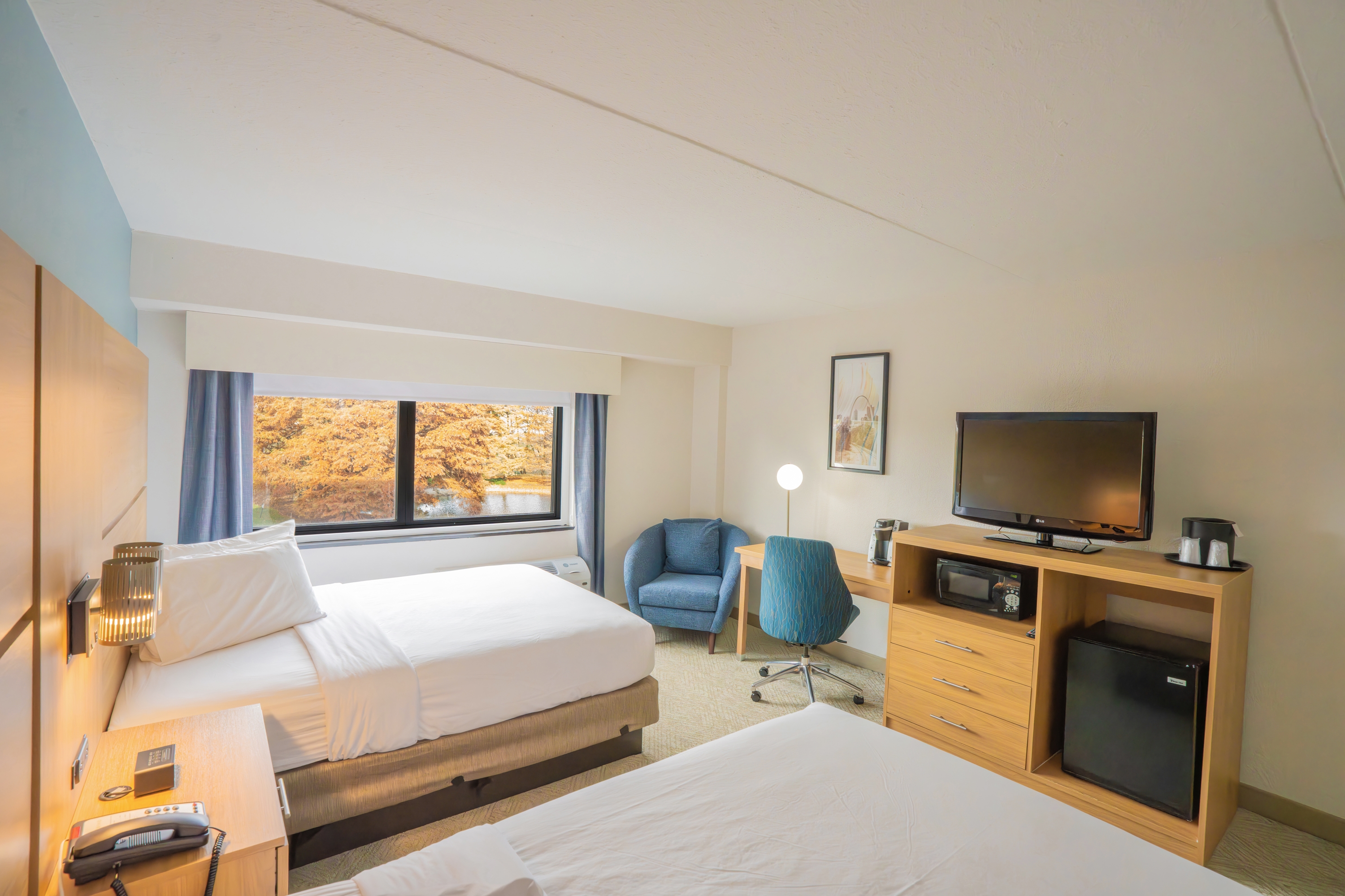 Guest room at the Elimwood Hotel, a Ramada by Wyndham in Maryland Heights, Missouri