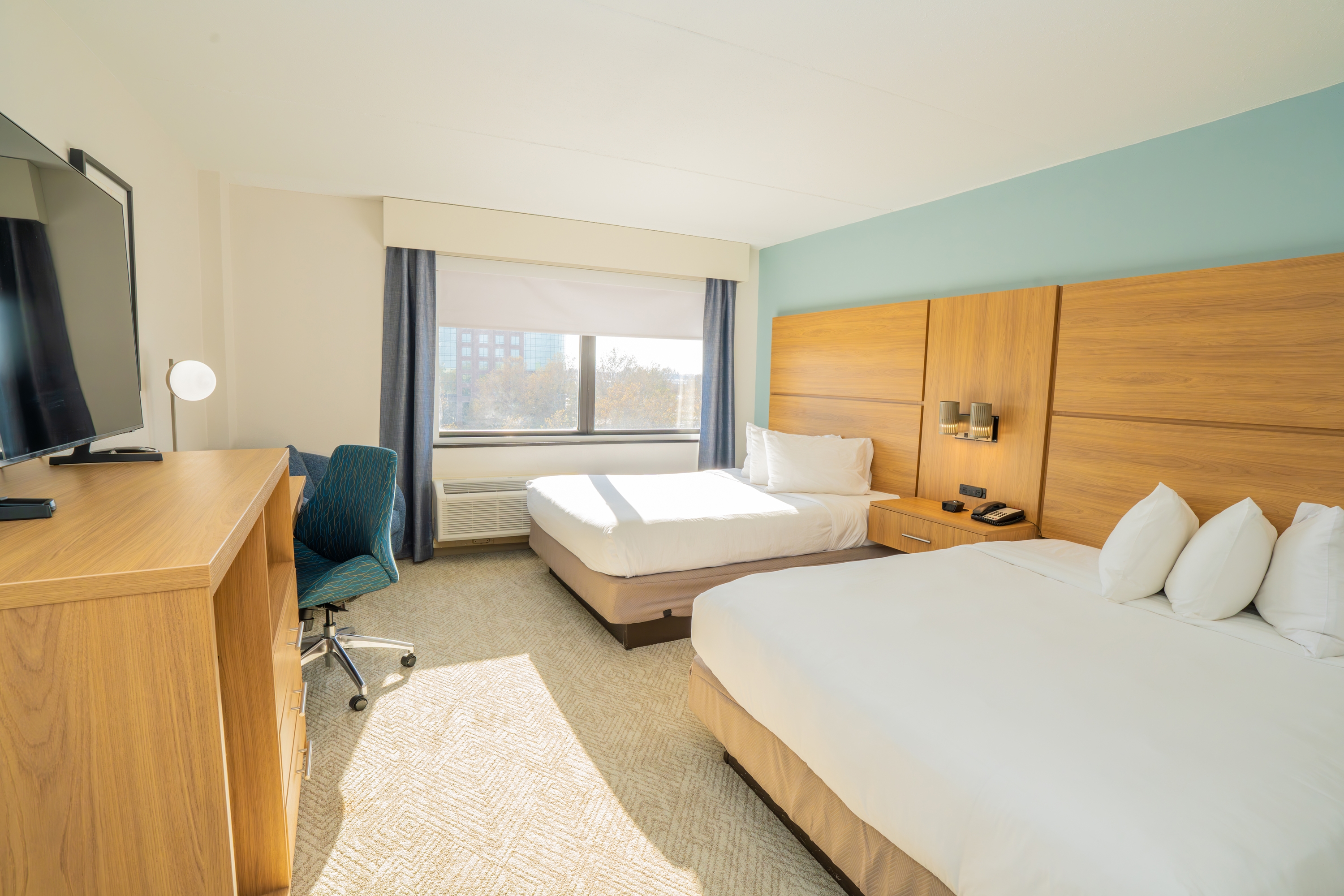 Guest room at the Elimwood Hotel, a Ramada by Wyndham in Maryland Heights, Missouri