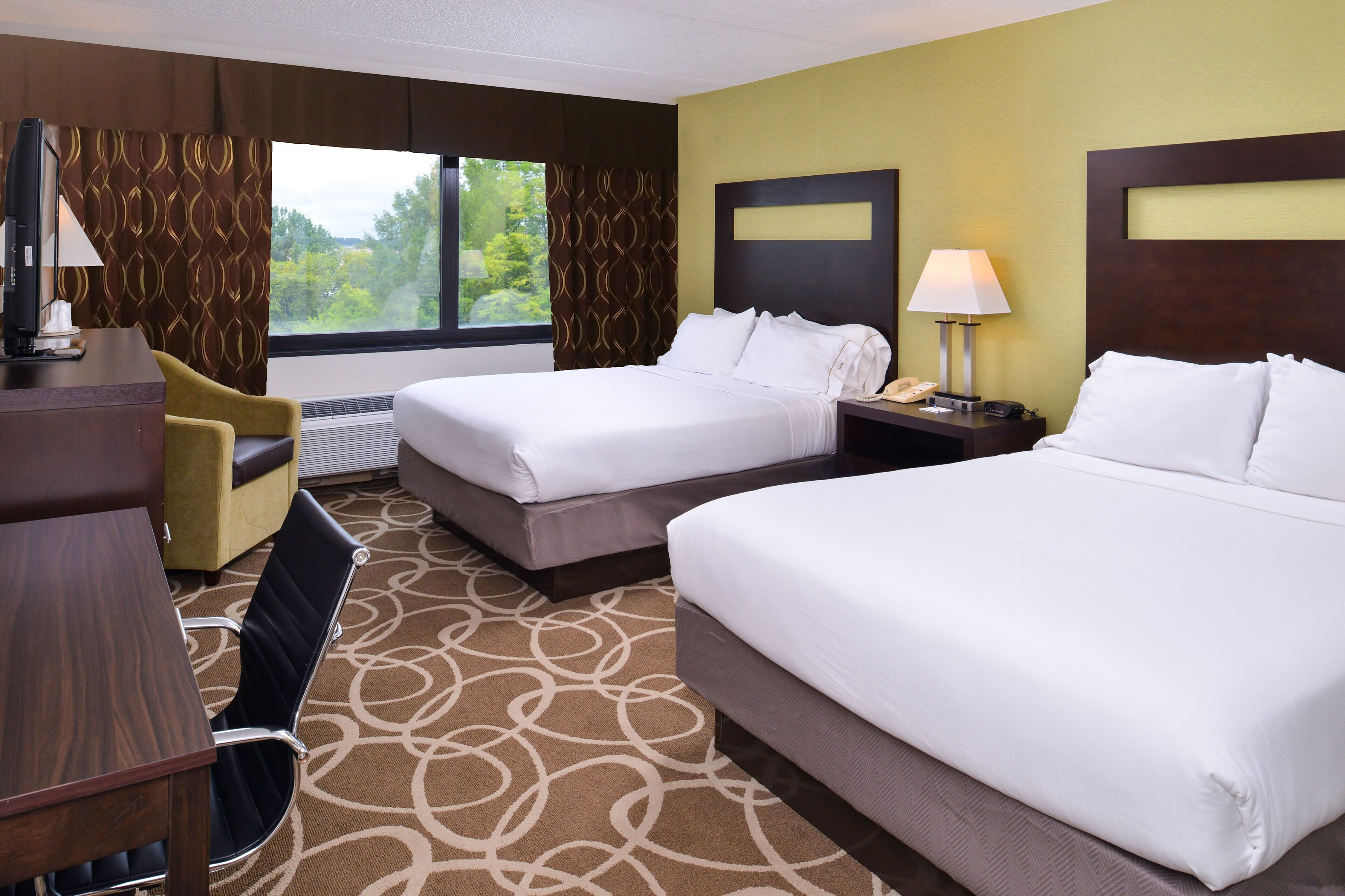 Guest room at the Elimwood Hotel, a Ramada by Wyndham in Maryland Heights, Missouri