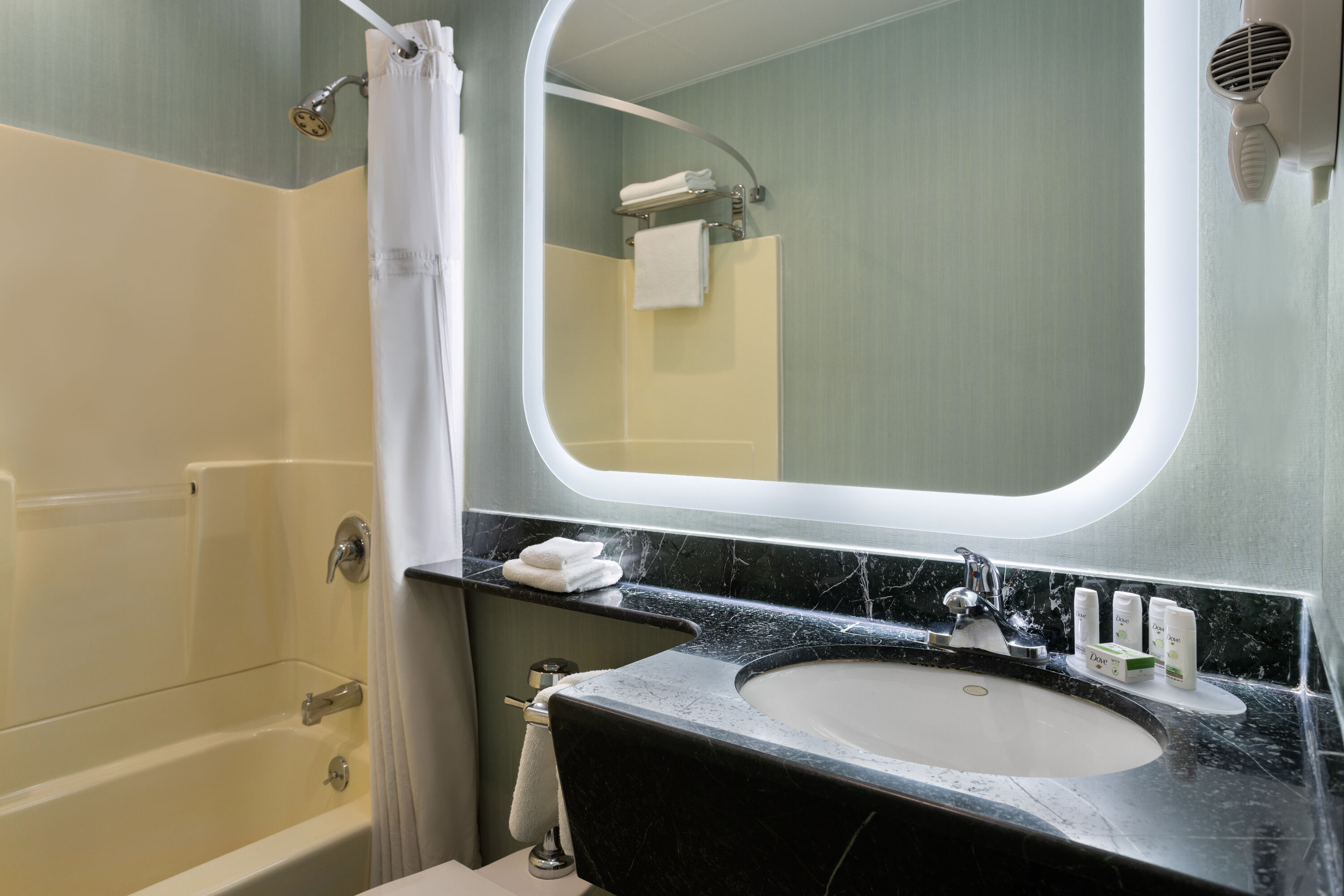 Guest room bath at the Ramada by Wyndham Bronx in Bronx, New York
