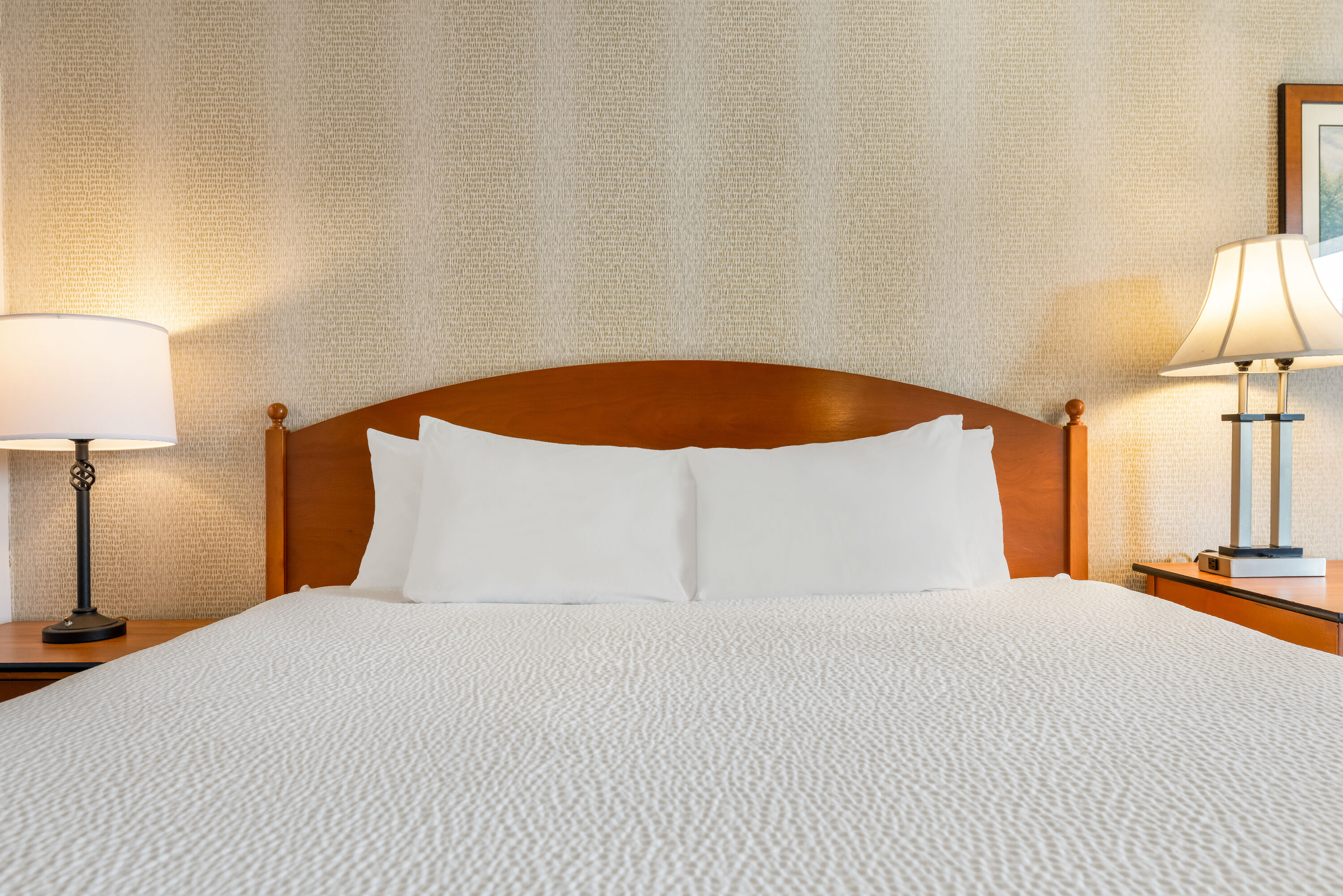 King bed guest room at the Ramada by Wyndham State College Hotel & Conference Center in State College, Pennsylvania