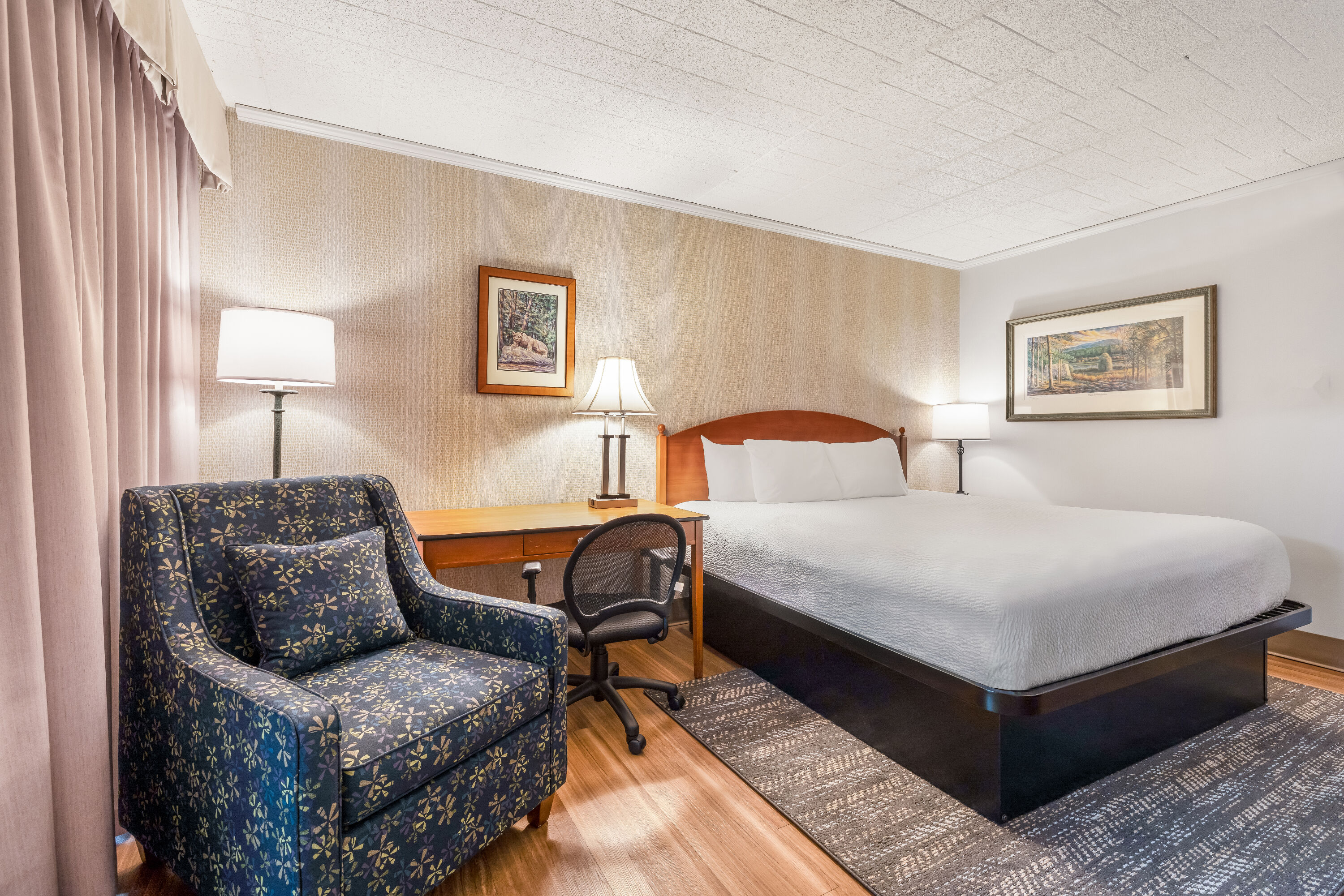 King bed guest room at the Ramada by Wyndham State College Hotel & Conference Center in State College, Pennsylvania