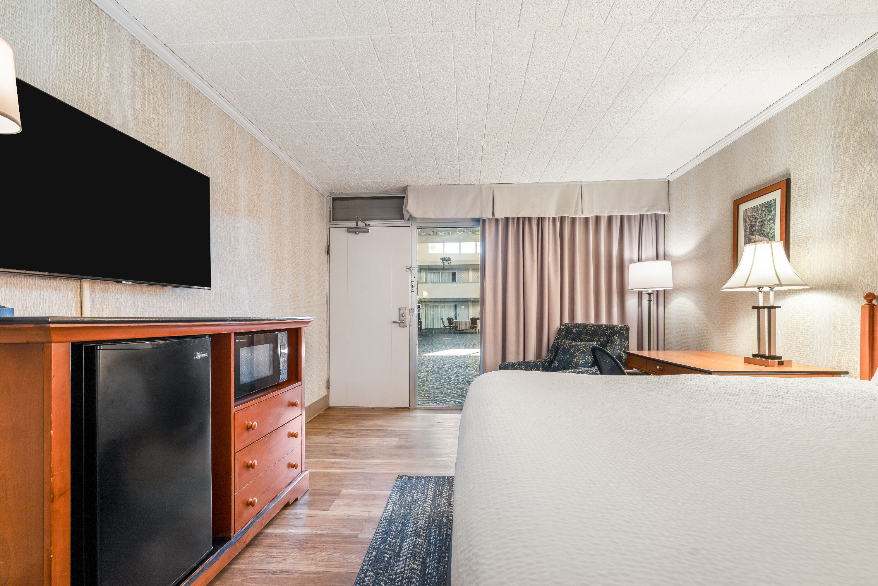 King bed guest room at the Ramada by Wyndham State College Hotel & Conference Center in State College, Pennsylvania