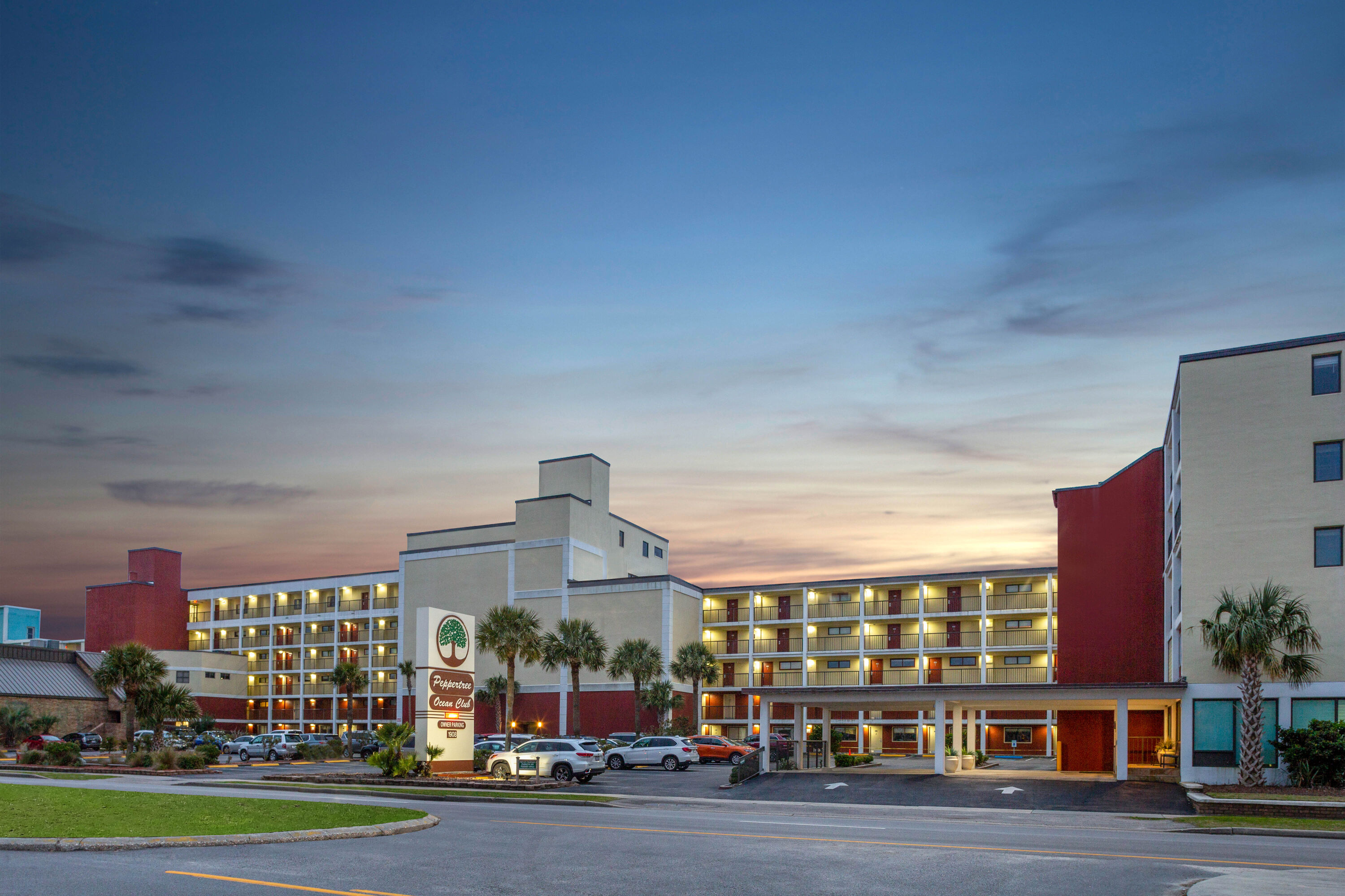Exterior Dusk Image of Ocean Club Resort Myrtle Beach a Ramada by Wyndham hotel in North Myrtle Beach, South Carolina