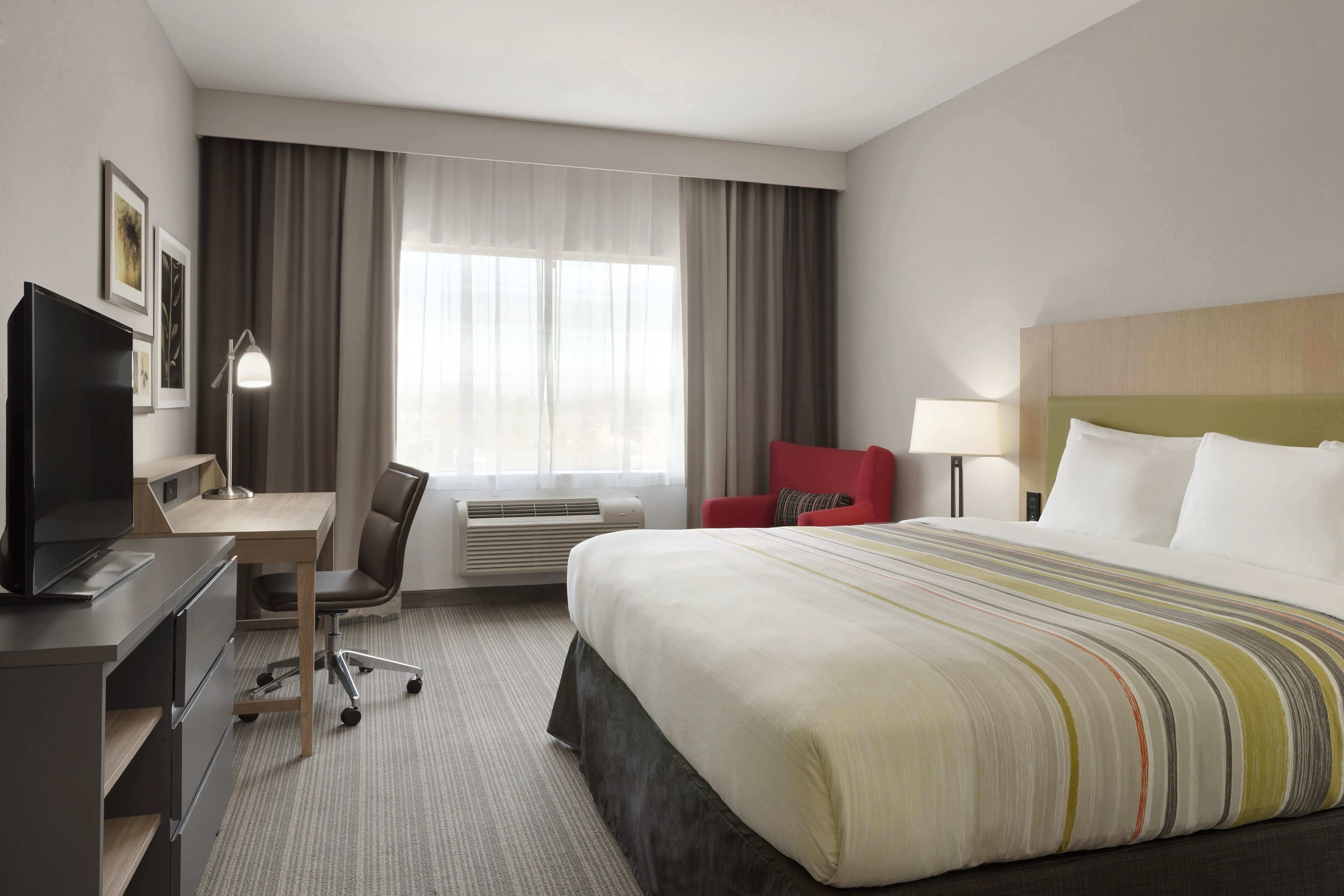 Guest room at the Ramada by Wyndham Houston Westchase in Houston, Texas