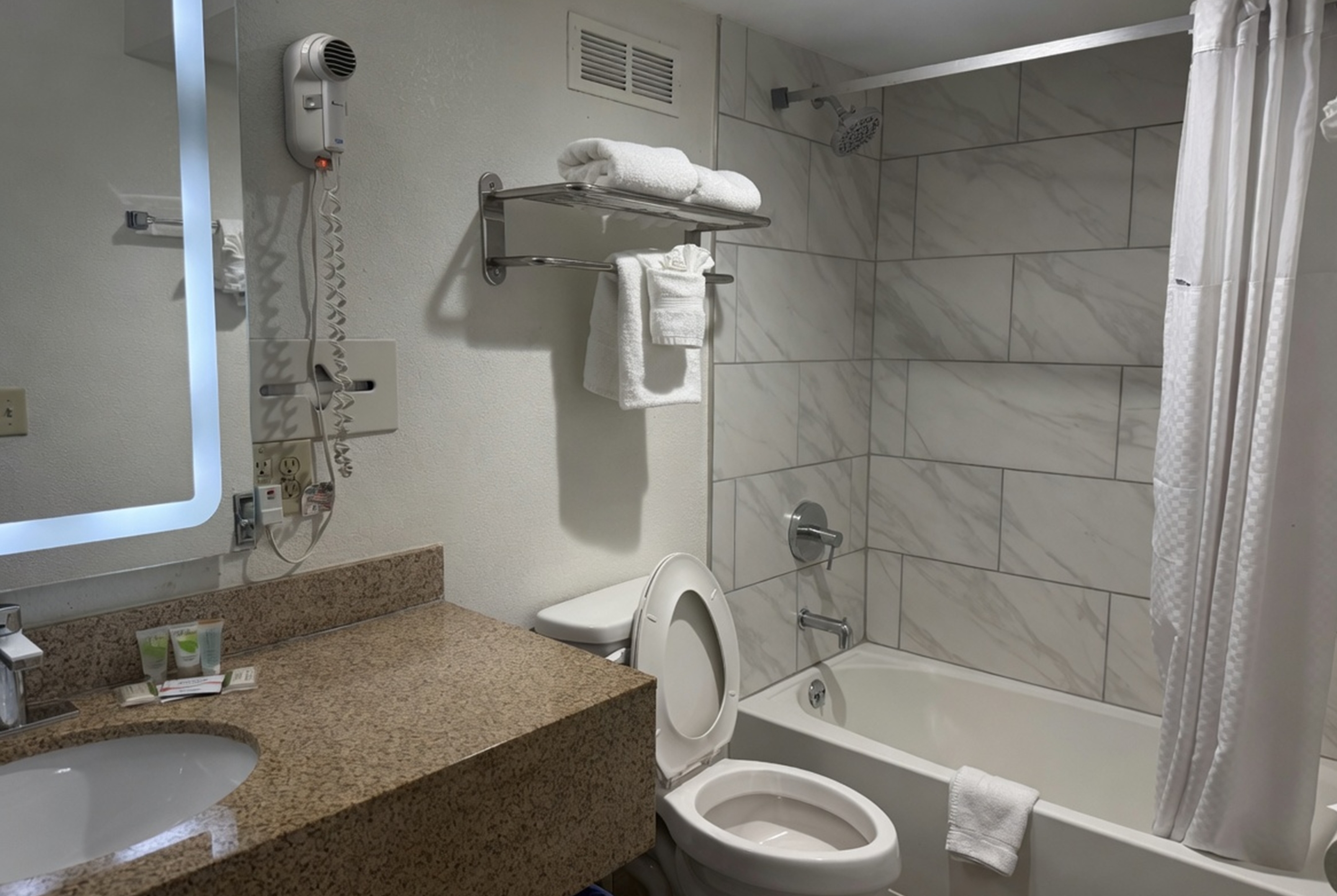 Guest room bath at the Ramada by Wyndham Harrisonburg in Harrisonburg, Virginia