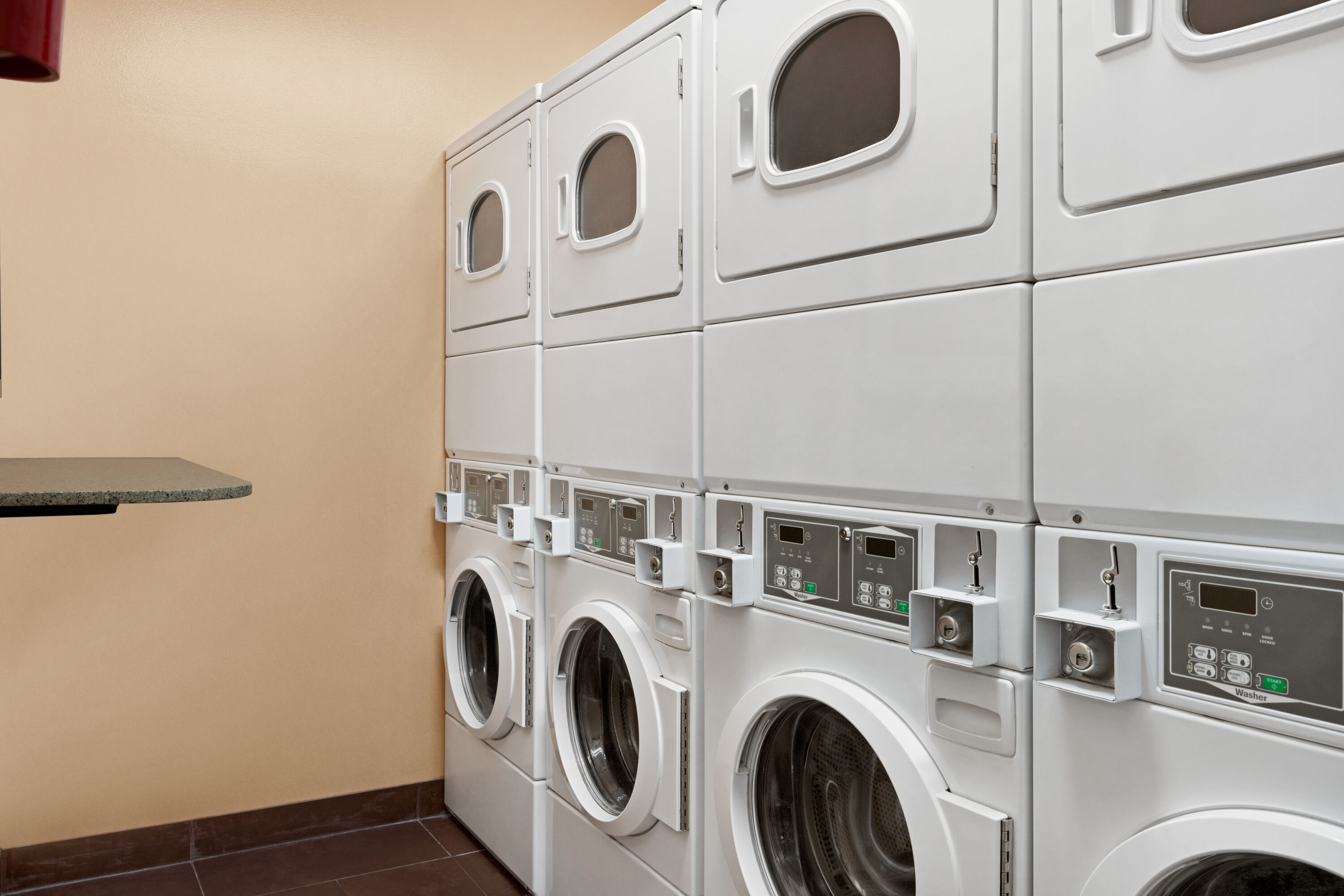 Laundry facilities at Super 8 by Wyndham Calgary Shawnessy Area in Calgary, Alberta