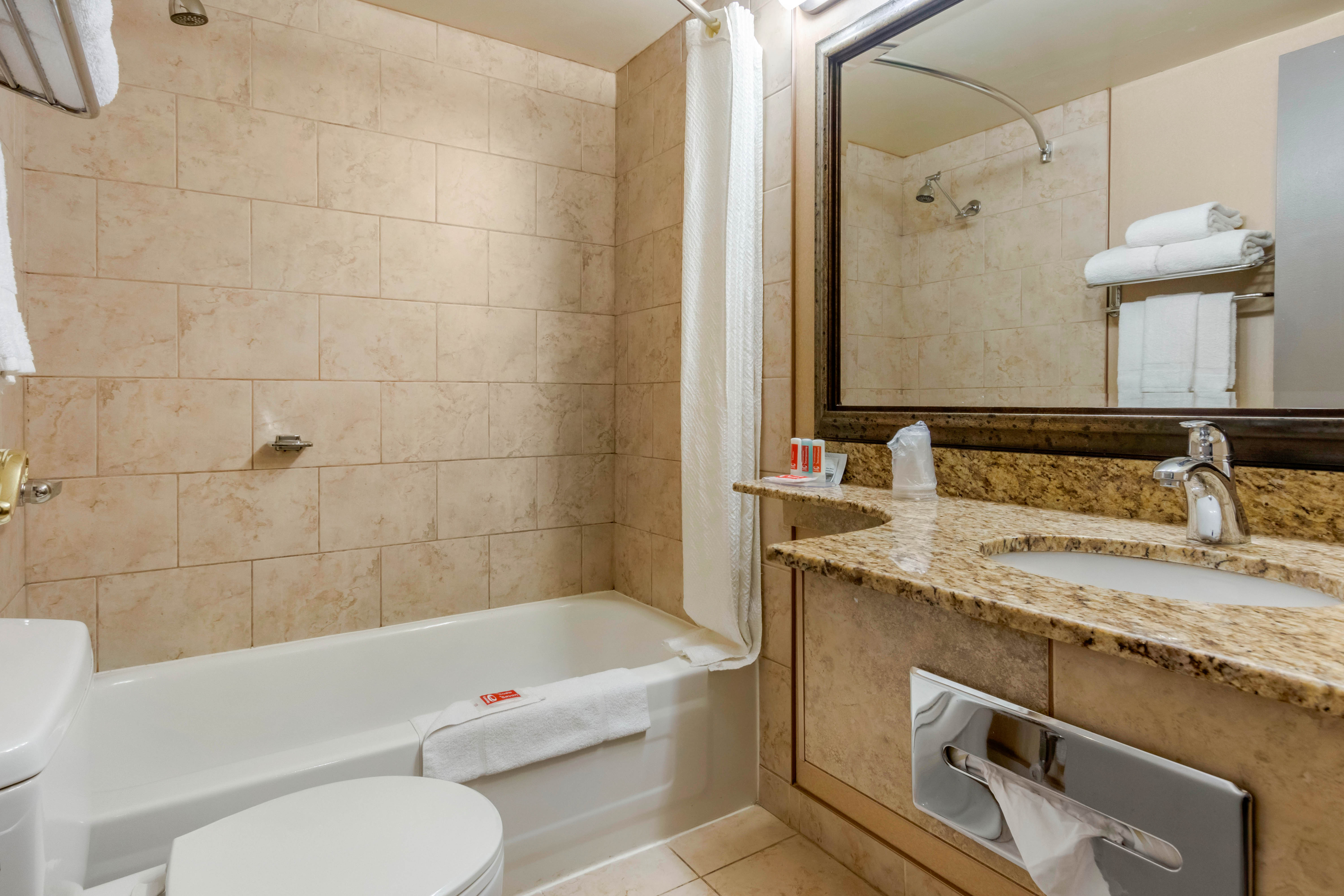 Guest room bath at the Super 8 by Wyndham Macleod Trail Calgary in Calgary, Alberta