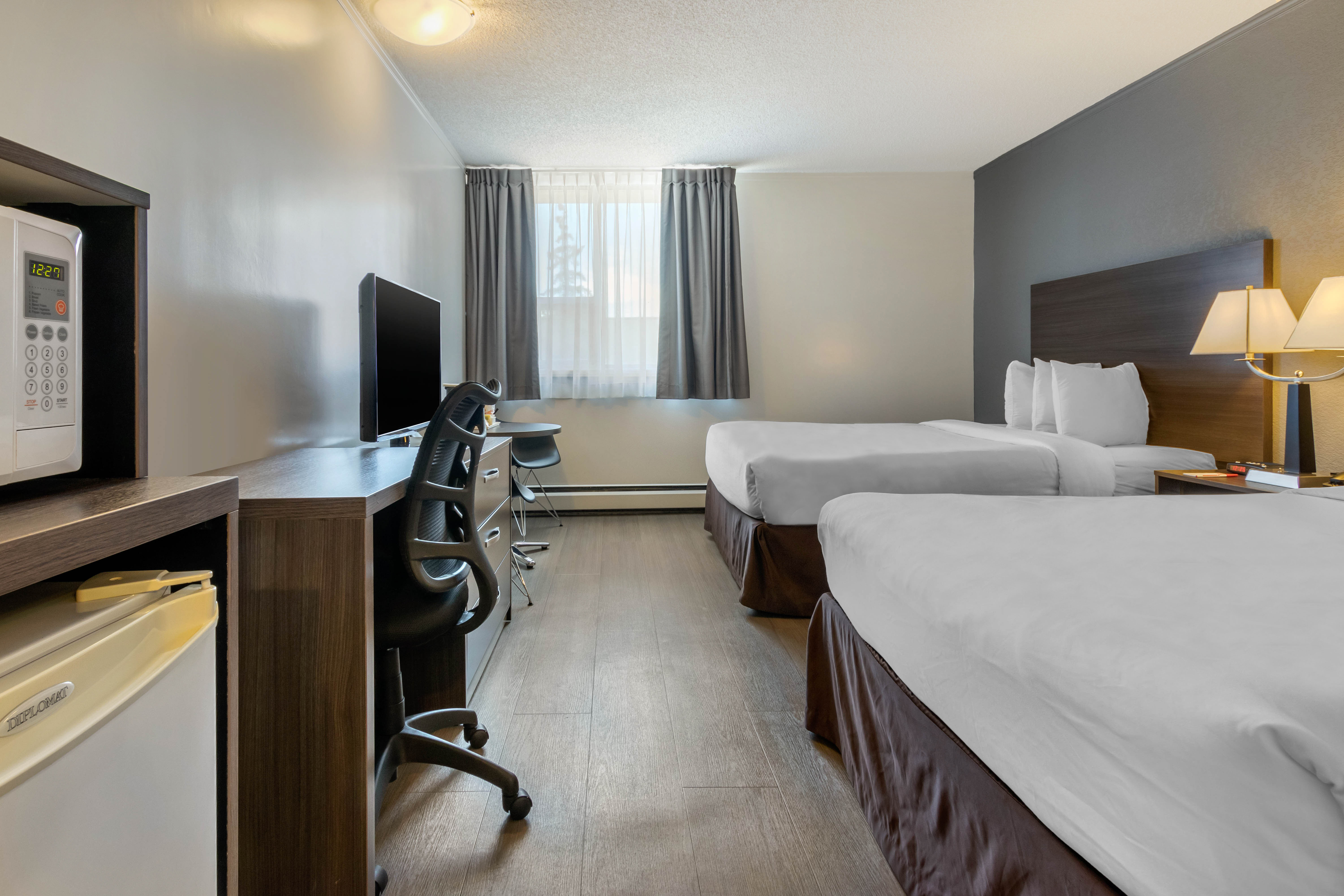 Guest room at the Super 8 by Wyndham Macleod Trail Calgary in Calgary, Alberta