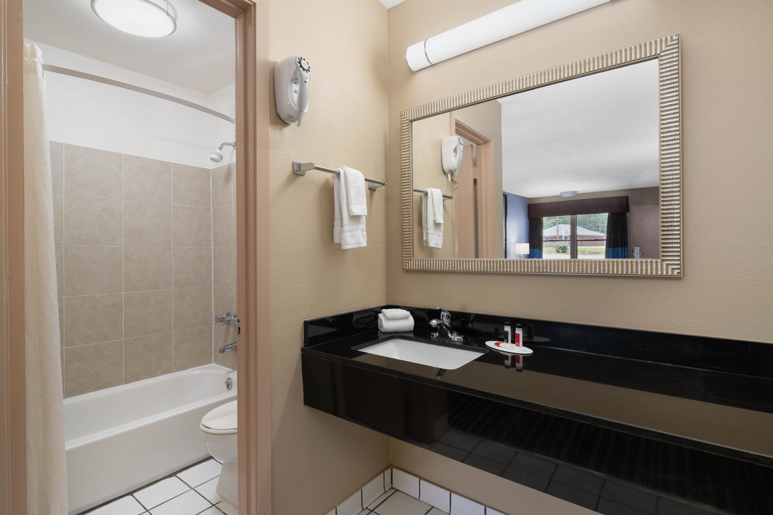 Guest room bath at the Super 8 by Wyndham Gadsden AL in Gadsden, Alabama