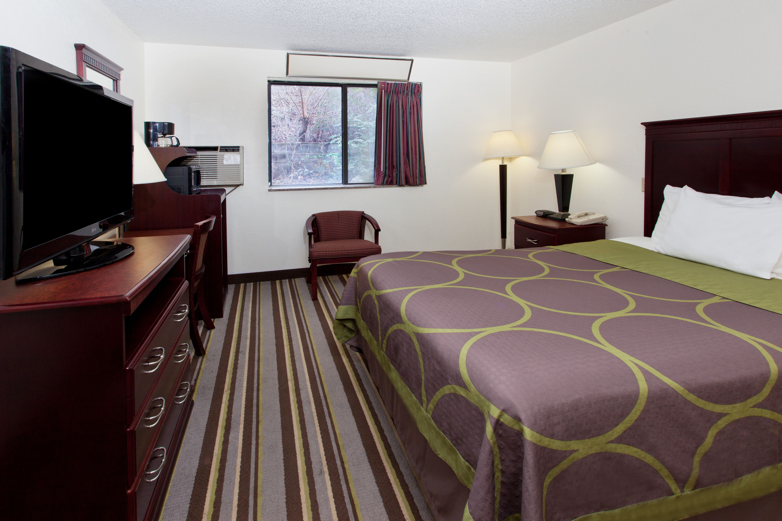 Guest room at the Super 8 by Wyndham Tuscaloosa in Tuscaloosa, Alabama