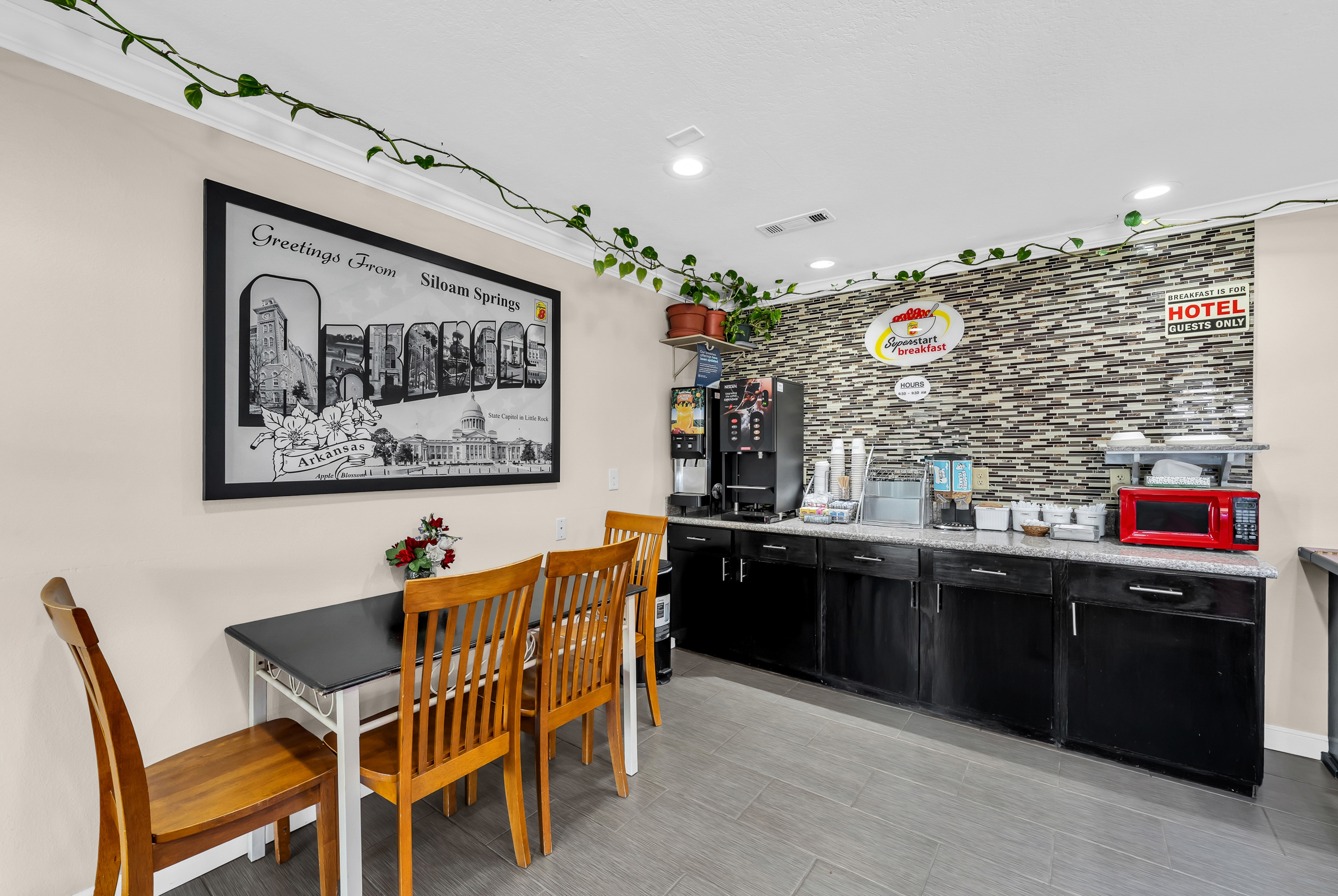 Super 8 by Wyndham Siloam Springs restaurant breakfast area with seating in Siloam Springs, Arkansas
