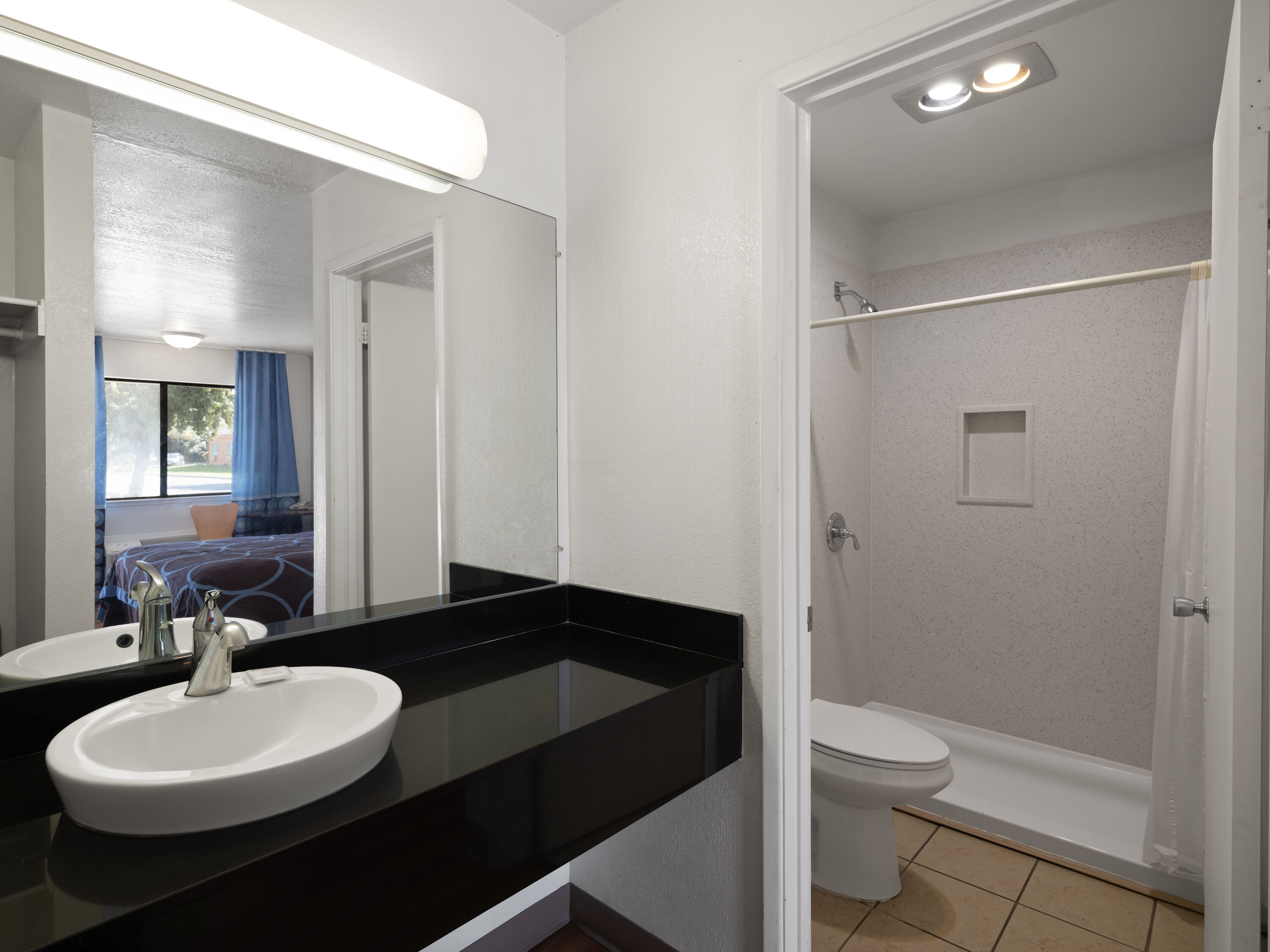Guest room bath at the Super 8 by Wyndham Dunnigan in Dunnigan, California