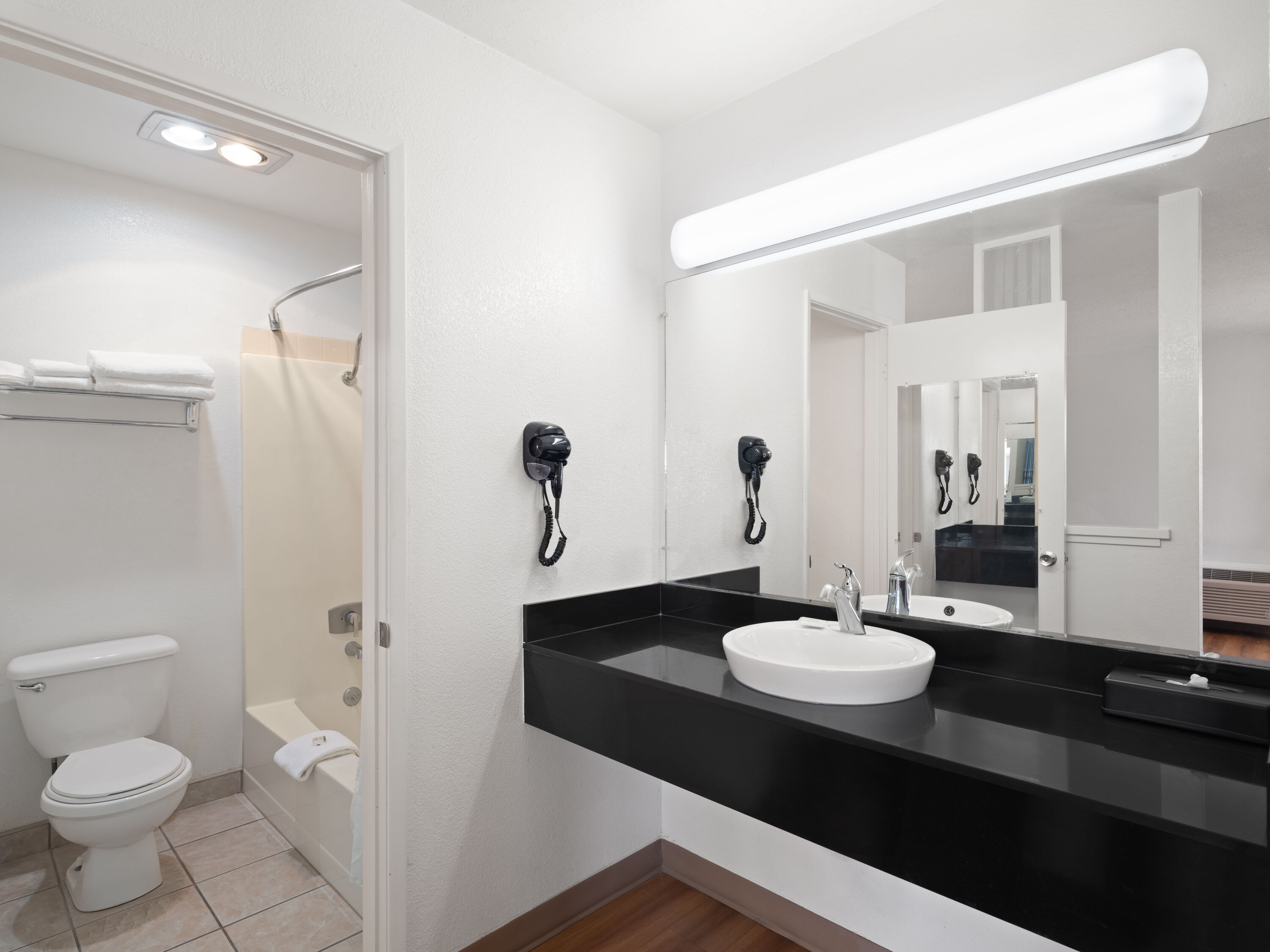 Guest room bath at the Super 8 by Wyndham Dunnigan in Dunnigan, California