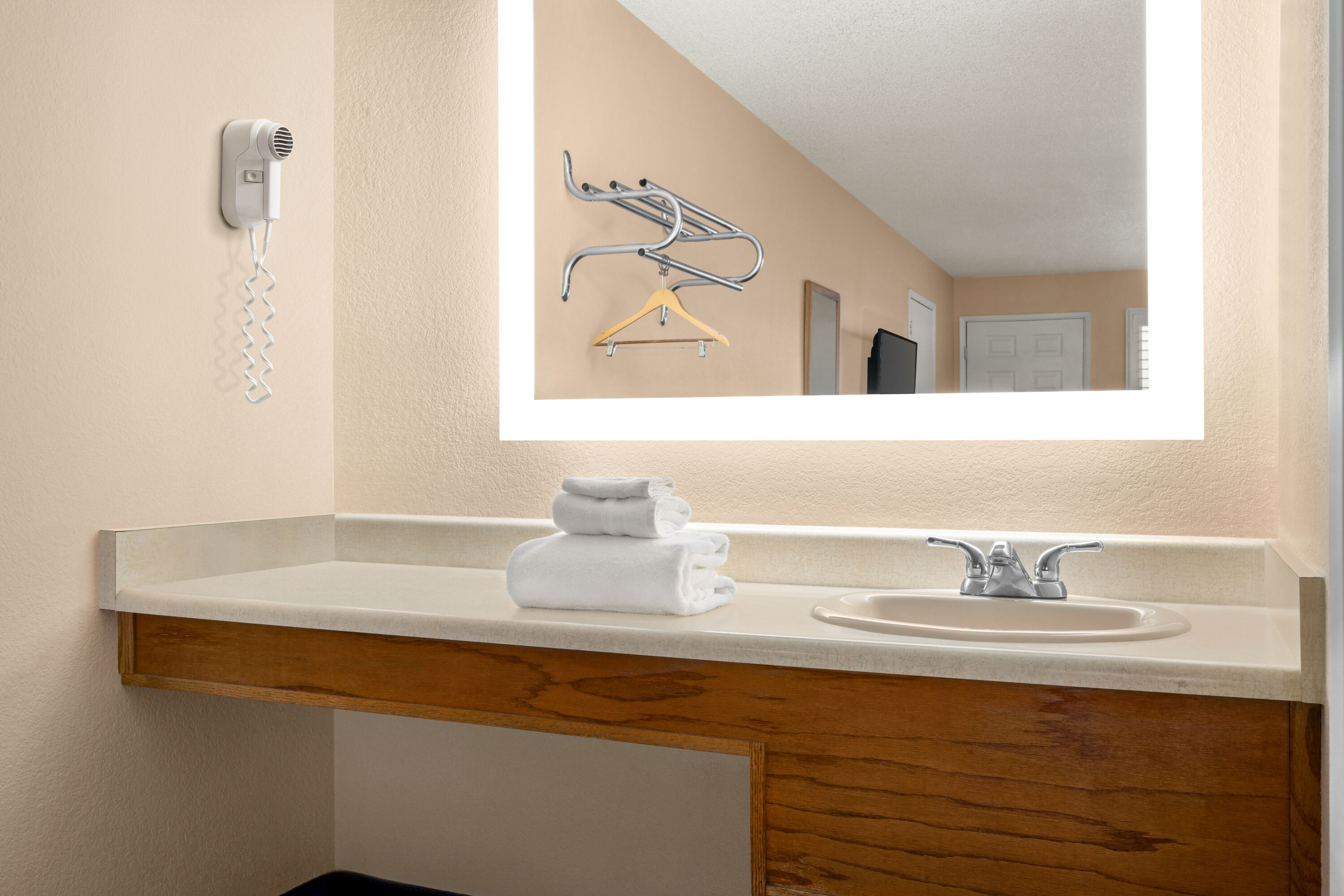 Guest room bath at the Super 8 by Wyndham Lindsay Olive Tree in Lindsay, California