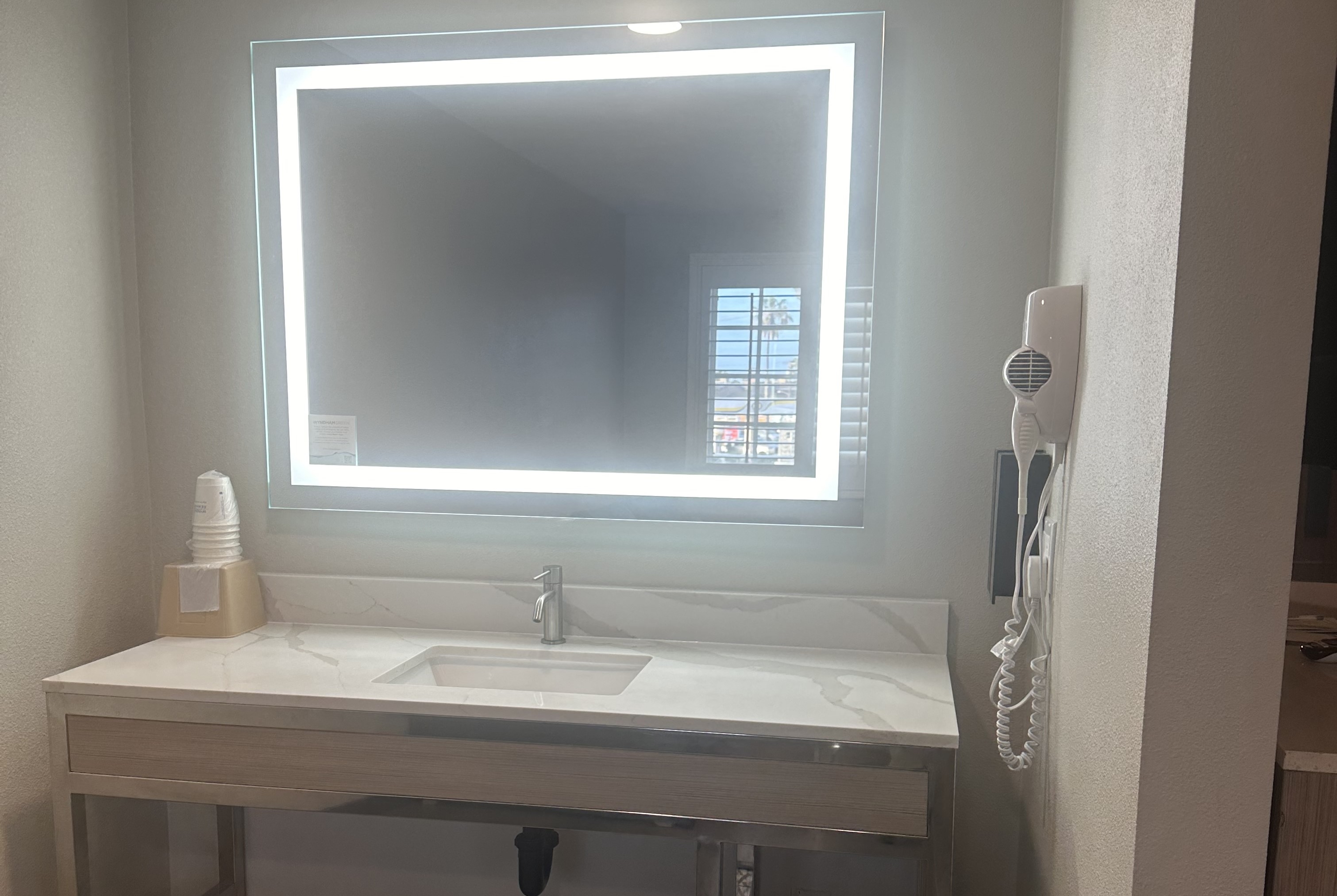 Guest room bath at the Super 8 by Wyndham Oceanside Downtown in Oceanside, California