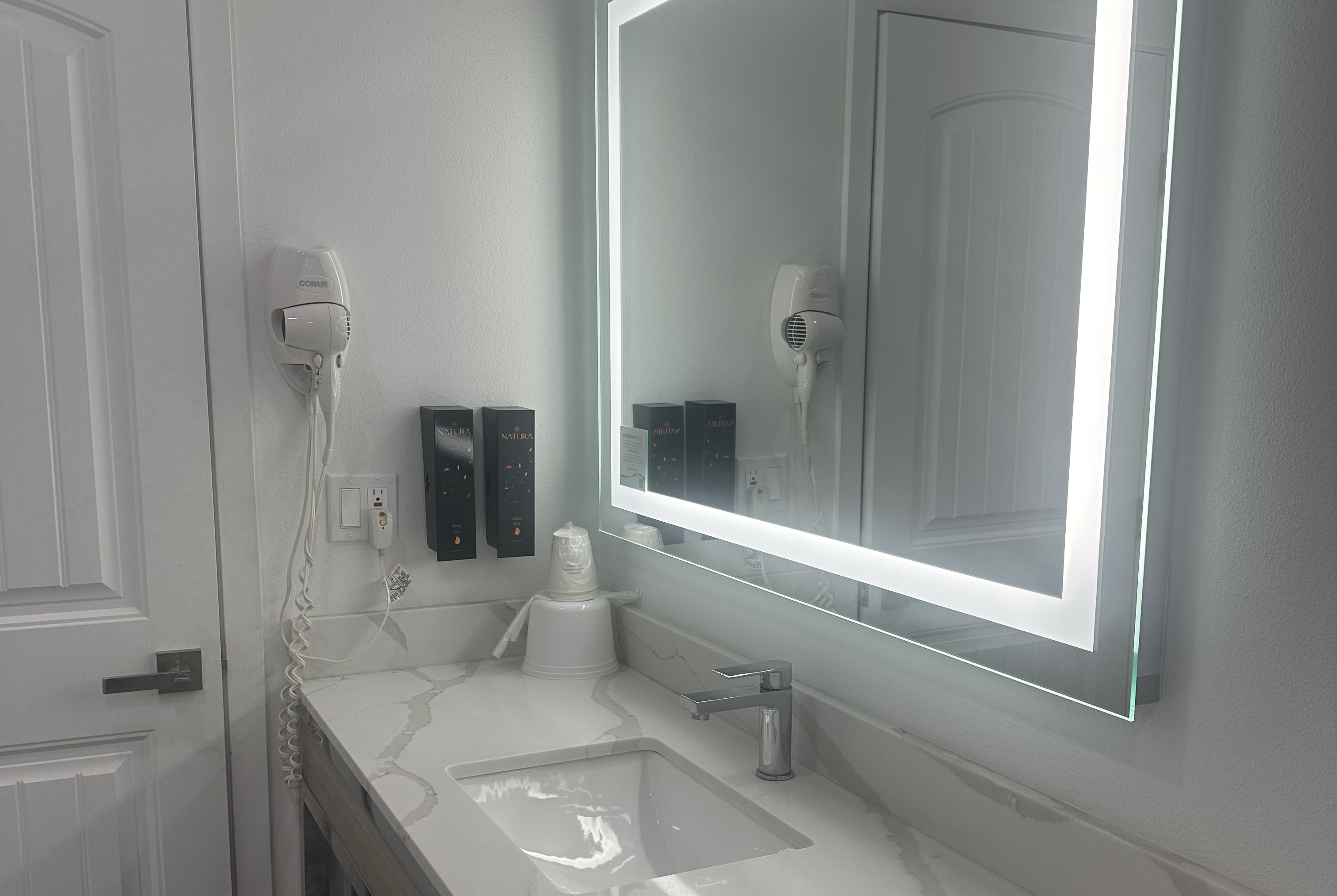 Guest room bath at the Super 8 by Wyndham Oceanside Downtown in Oceanside, California