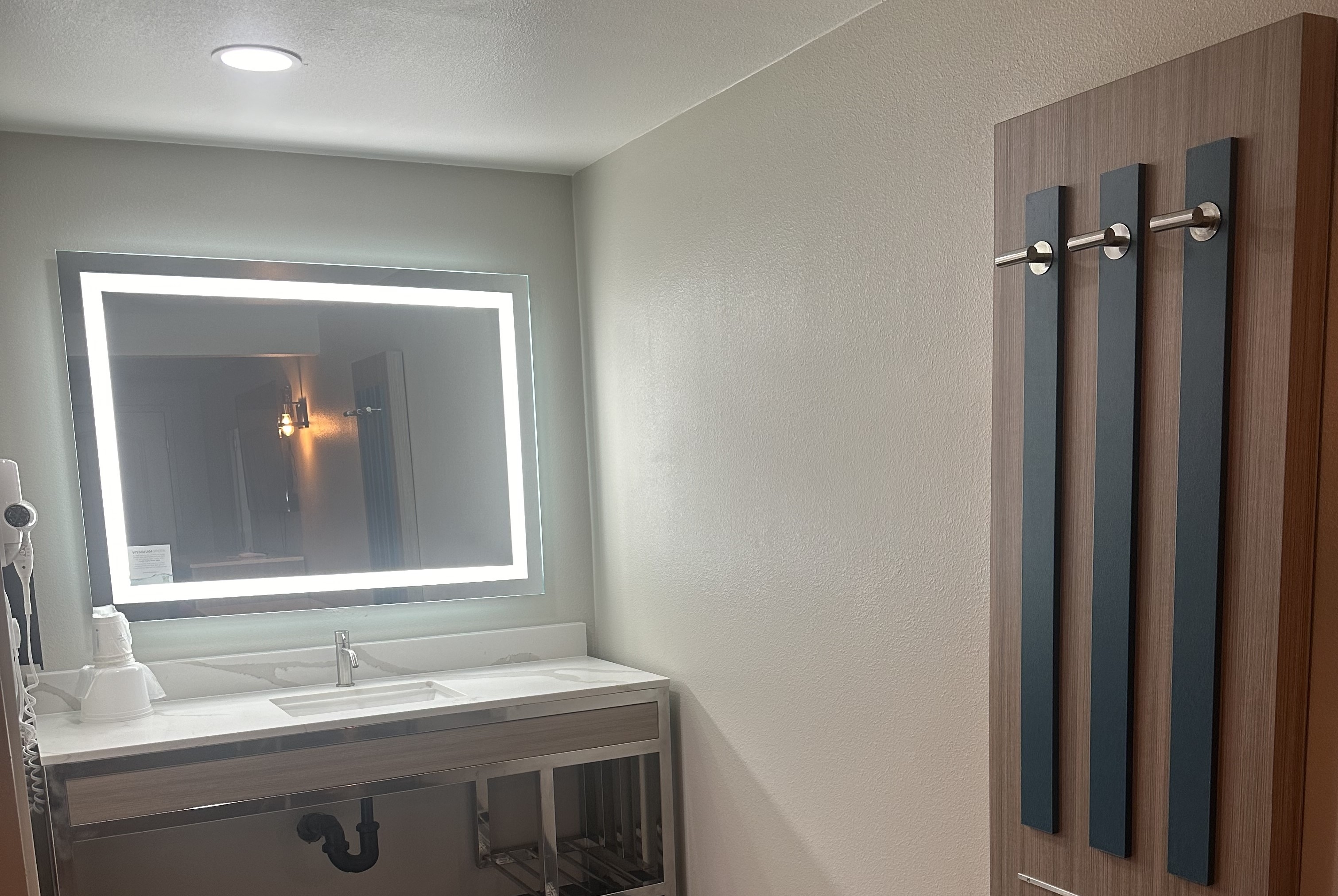 Guest room bath at the Super 8 by Wyndham Oceanside Downtown in Oceanside, California