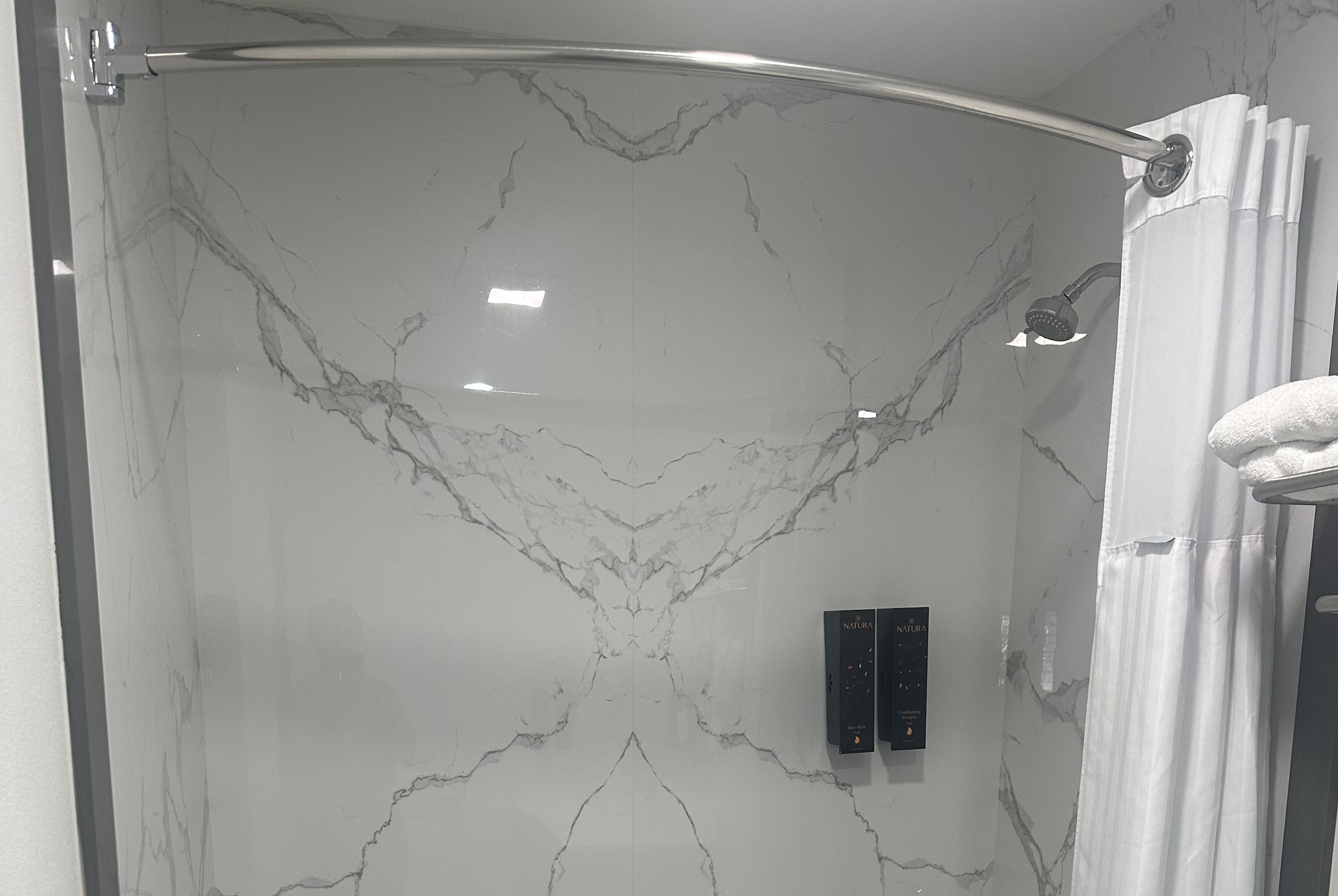 Guest room bath at the Super 8 by Wyndham Oceanside Downtown in Oceanside, California