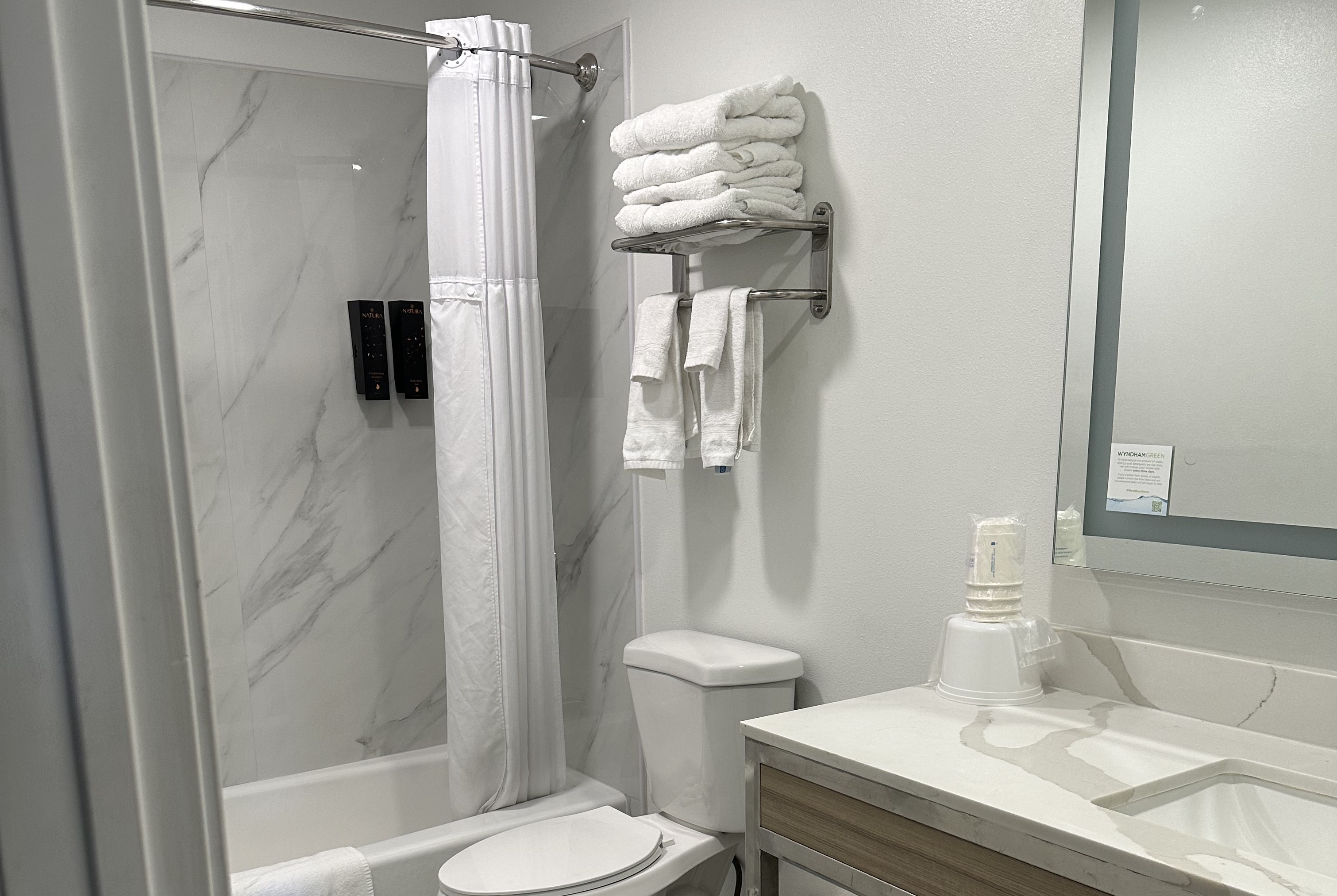 Guest room bath at the Super 8 by Wyndham Oceanside Downtown in Oceanside, California