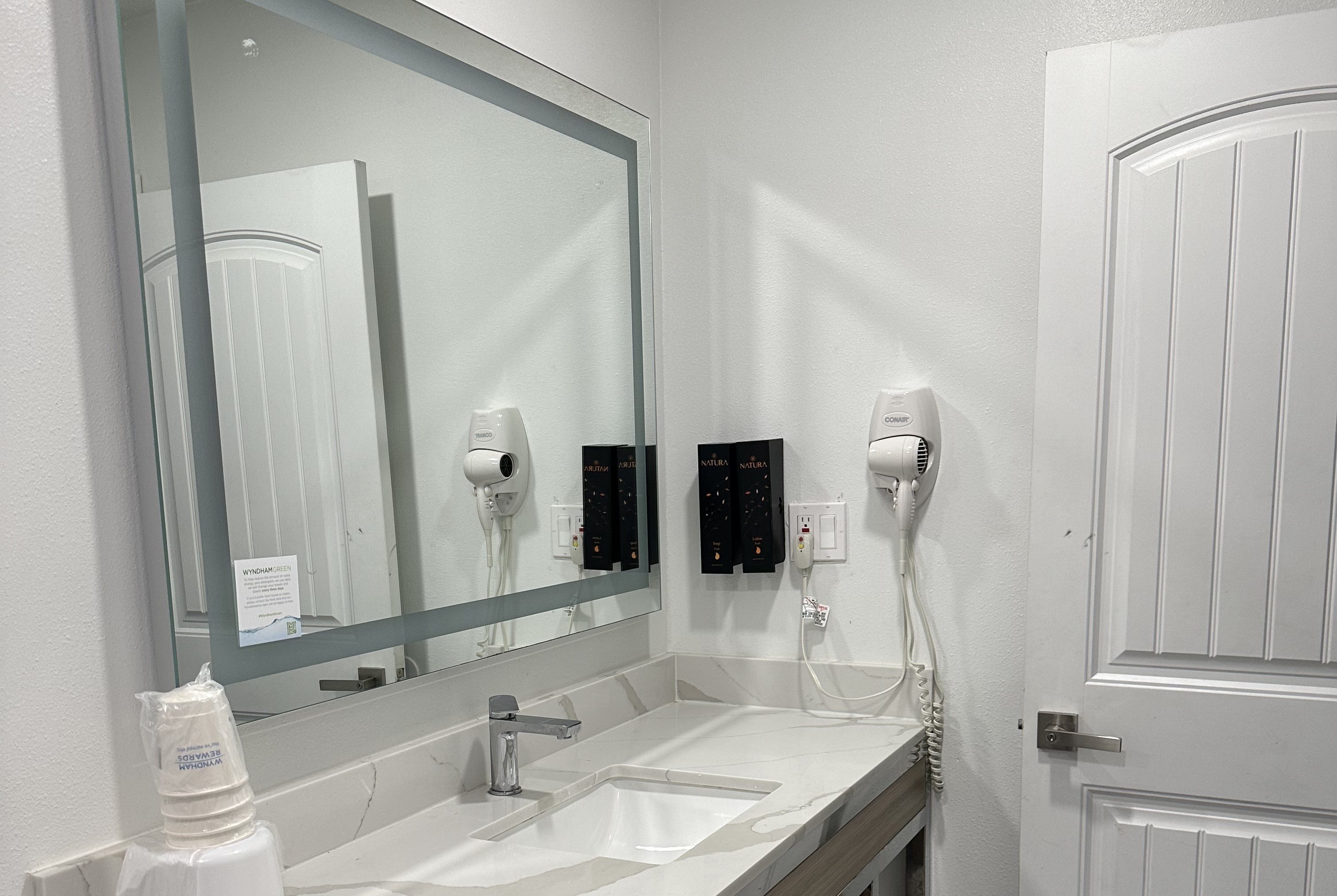 Guest room bath at the Super 8 by Wyndham Oceanside Downtown in Oceanside, California