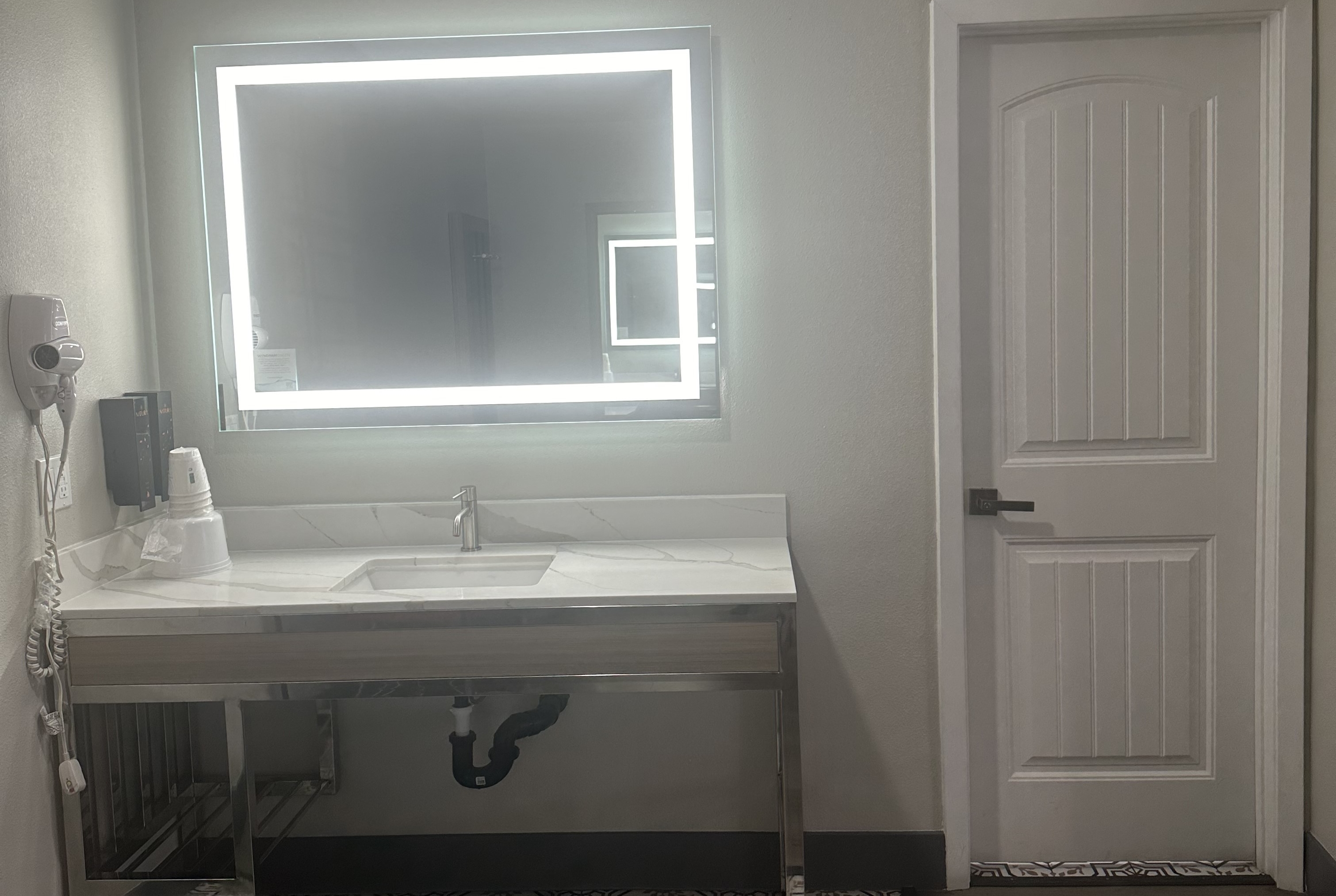 Guest room bath at the Super 8 by Wyndham Oceanside Downtown in Oceanside, California