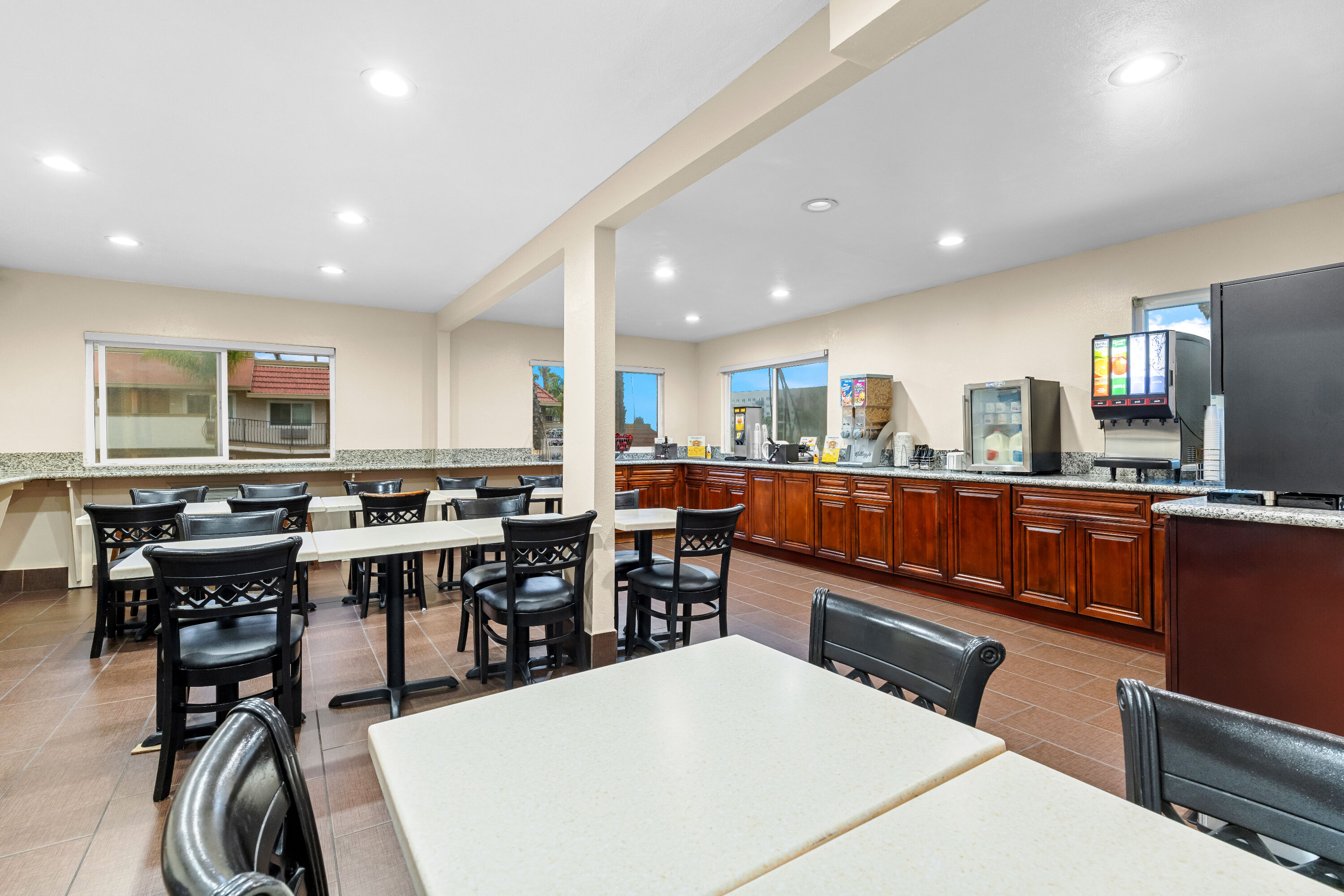 Super 8 by Wyndham San Diego Hotel Circle restaurant breakfast area with seating in San Diego, California