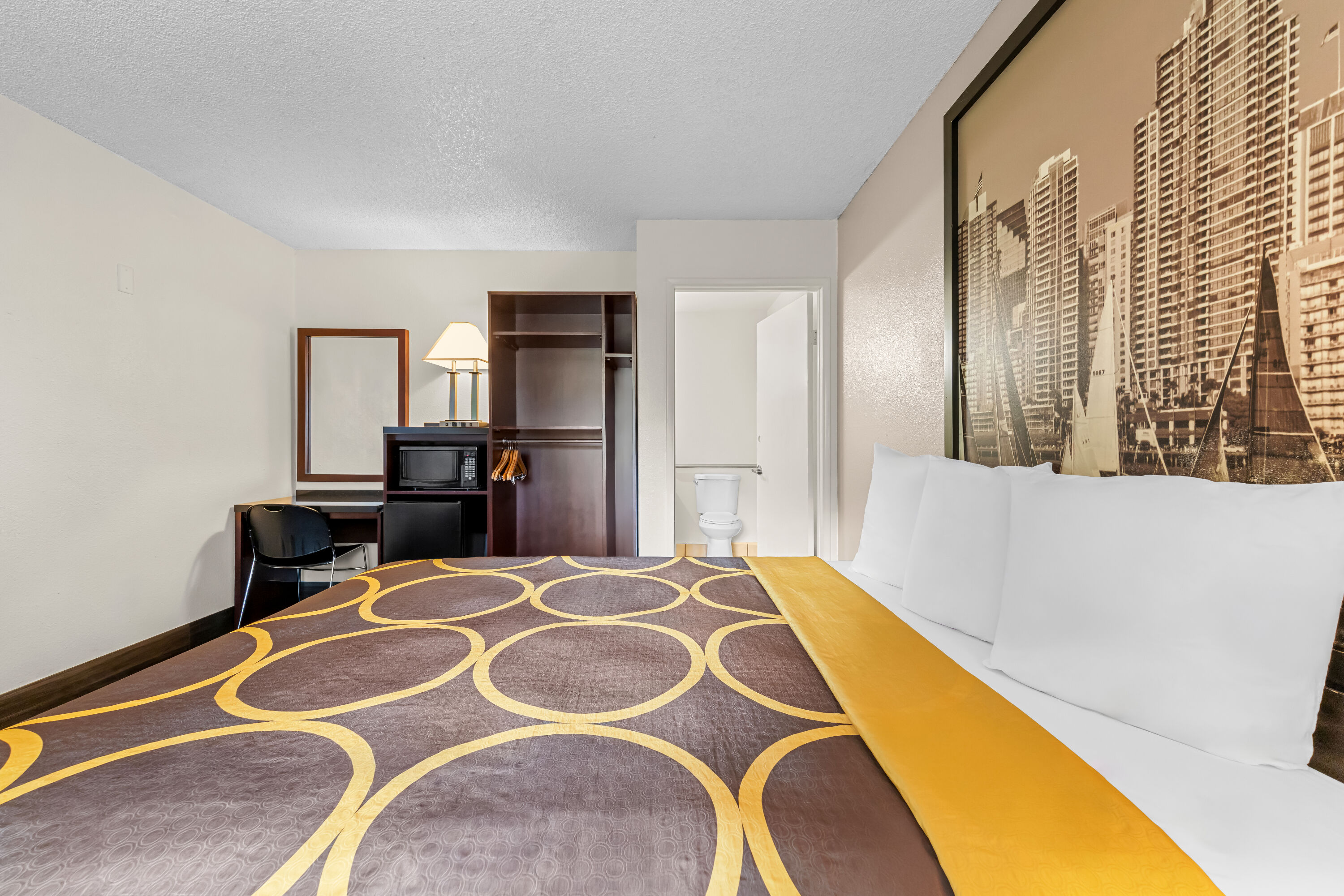 Queen bed guest room at the Super 8 by Wyndham San Diego Hotel Circle in San Diego, California
