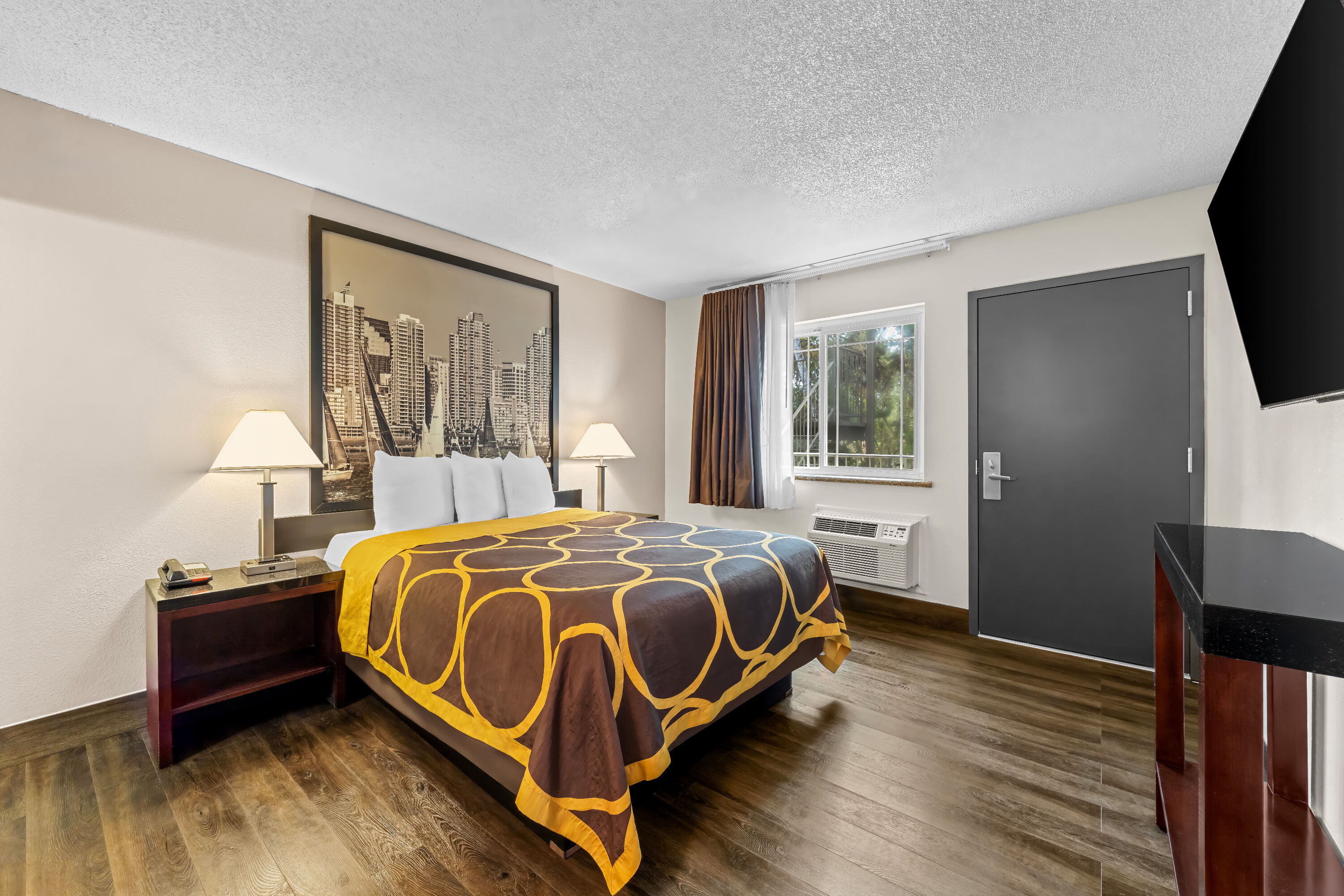 Queen bed guest room at the Super 8 by Wyndham San Diego Hotel Circle in San Diego, California
