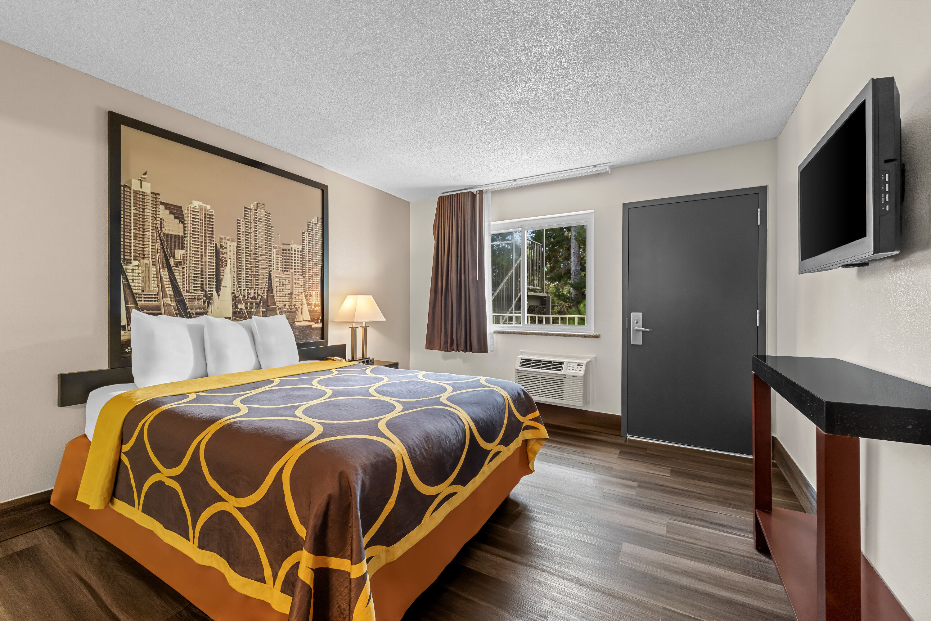 Queen bed guest room at the Super 8 by Wyndham San Diego Hotel Circle in San Diego, California