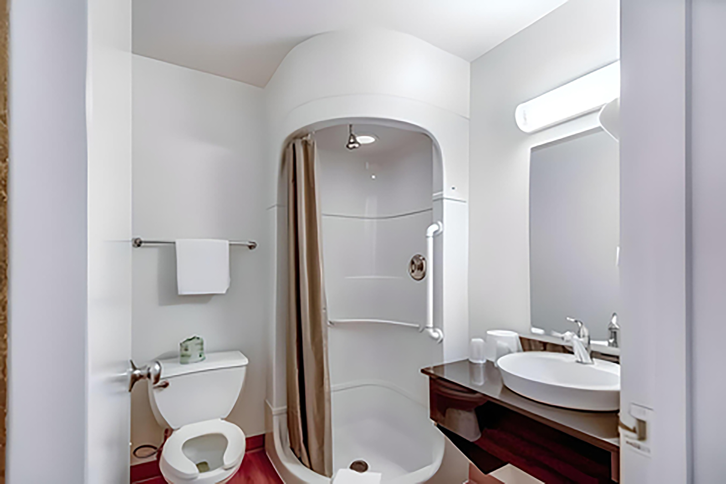 Guest room bath at the Super 8 by Wyndham Tracy in Tracy, California