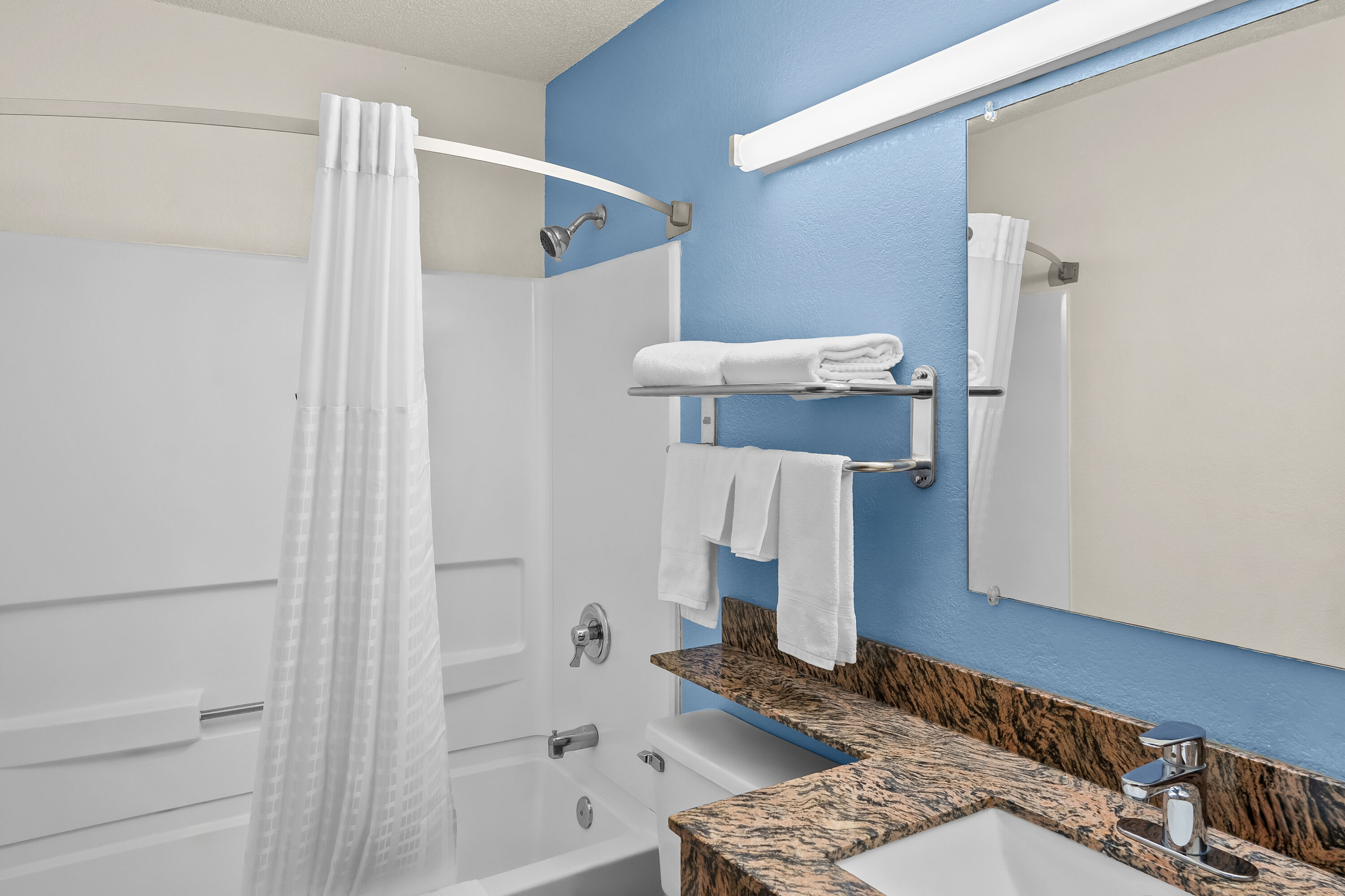Guest room bath at the Super 8 by Wyndham New Castle in New Castle, Delaware