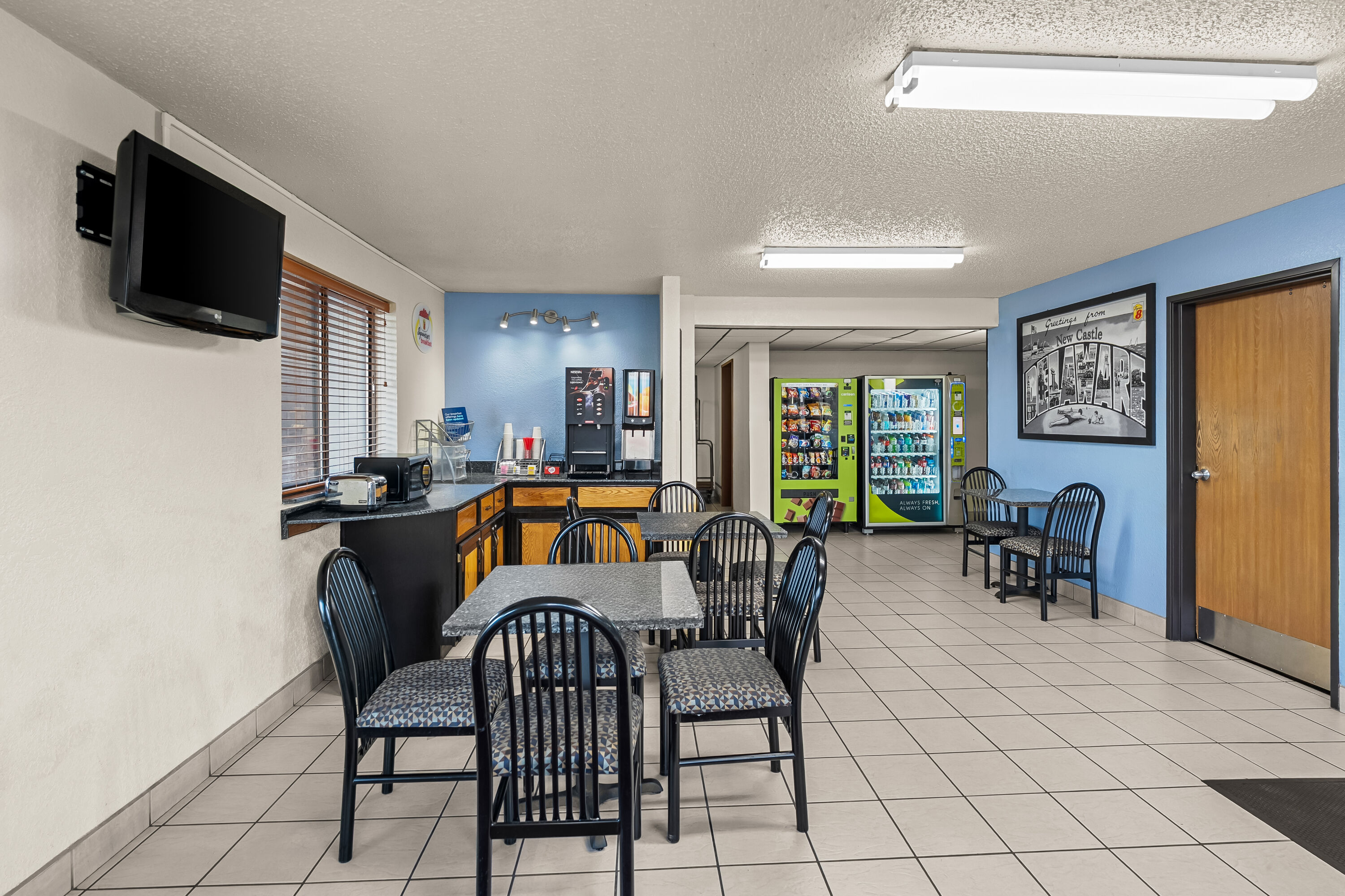 Super 8 by Wyndham New Castle restaurant breakfast area with seating in New Castle, Delaware