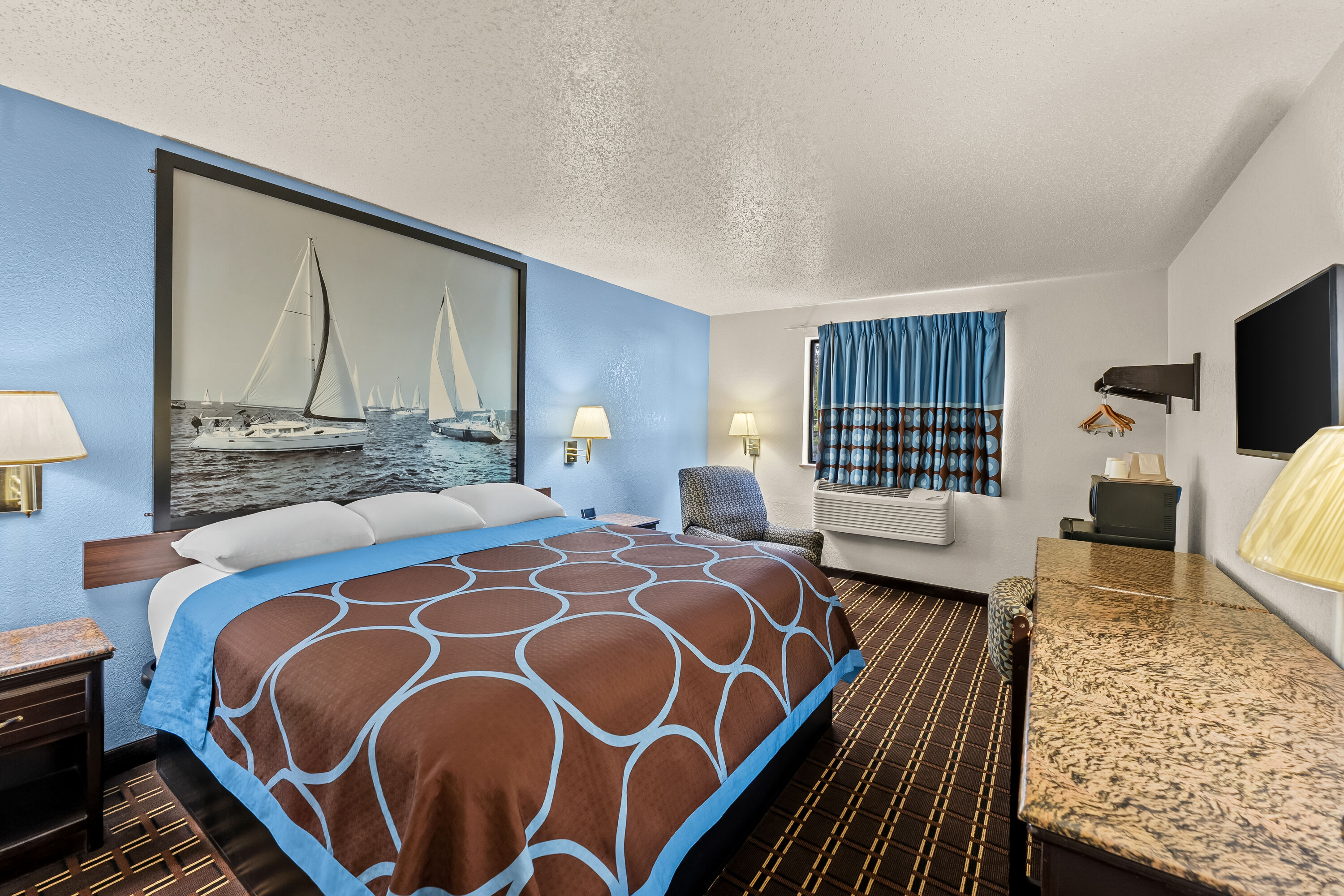 Queen bed guest room at the Super 8 by Wyndham New Castle in New Castle, Delaware