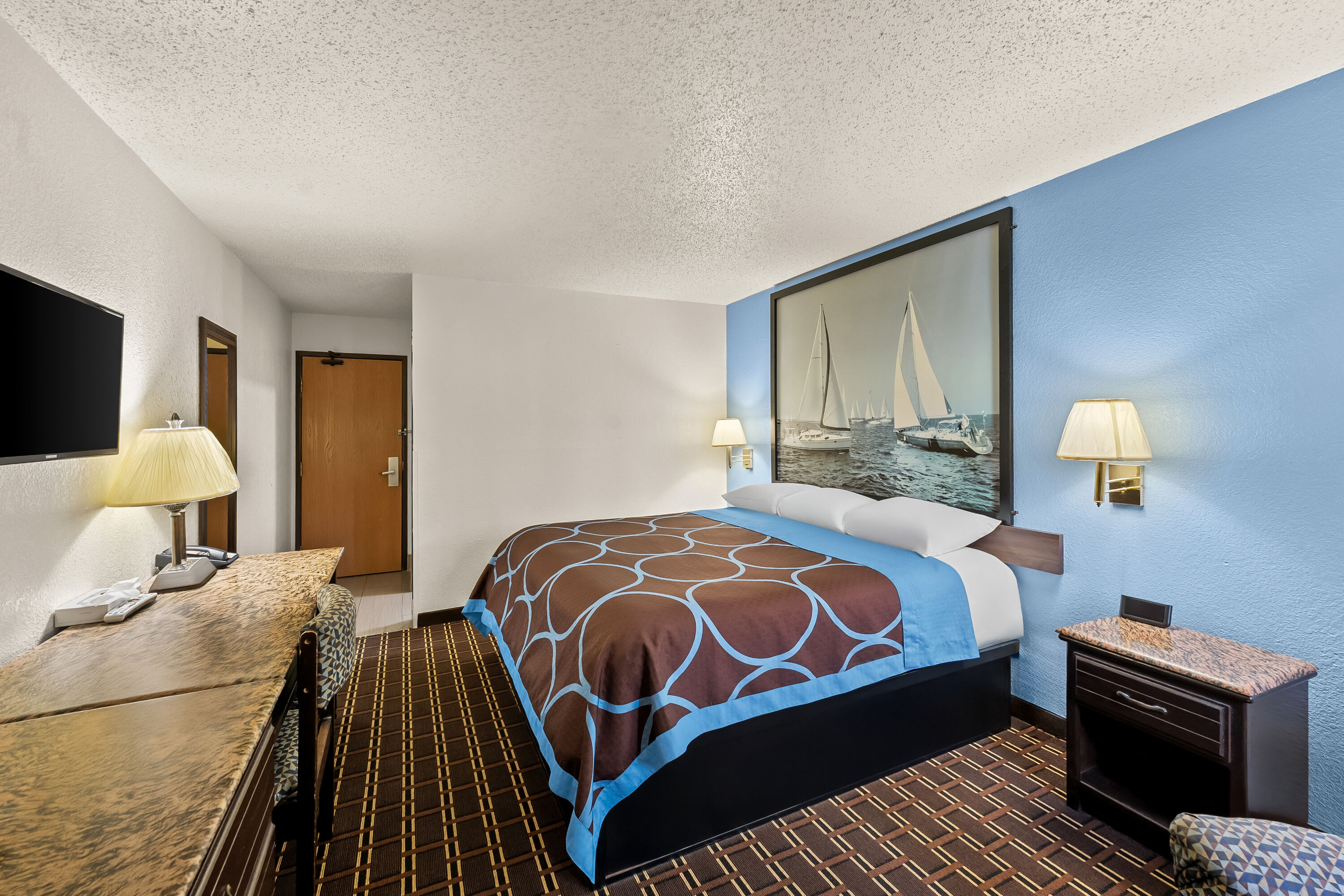 Queen bed guest room at the Super 8 by Wyndham New Castle in New Castle, Delaware