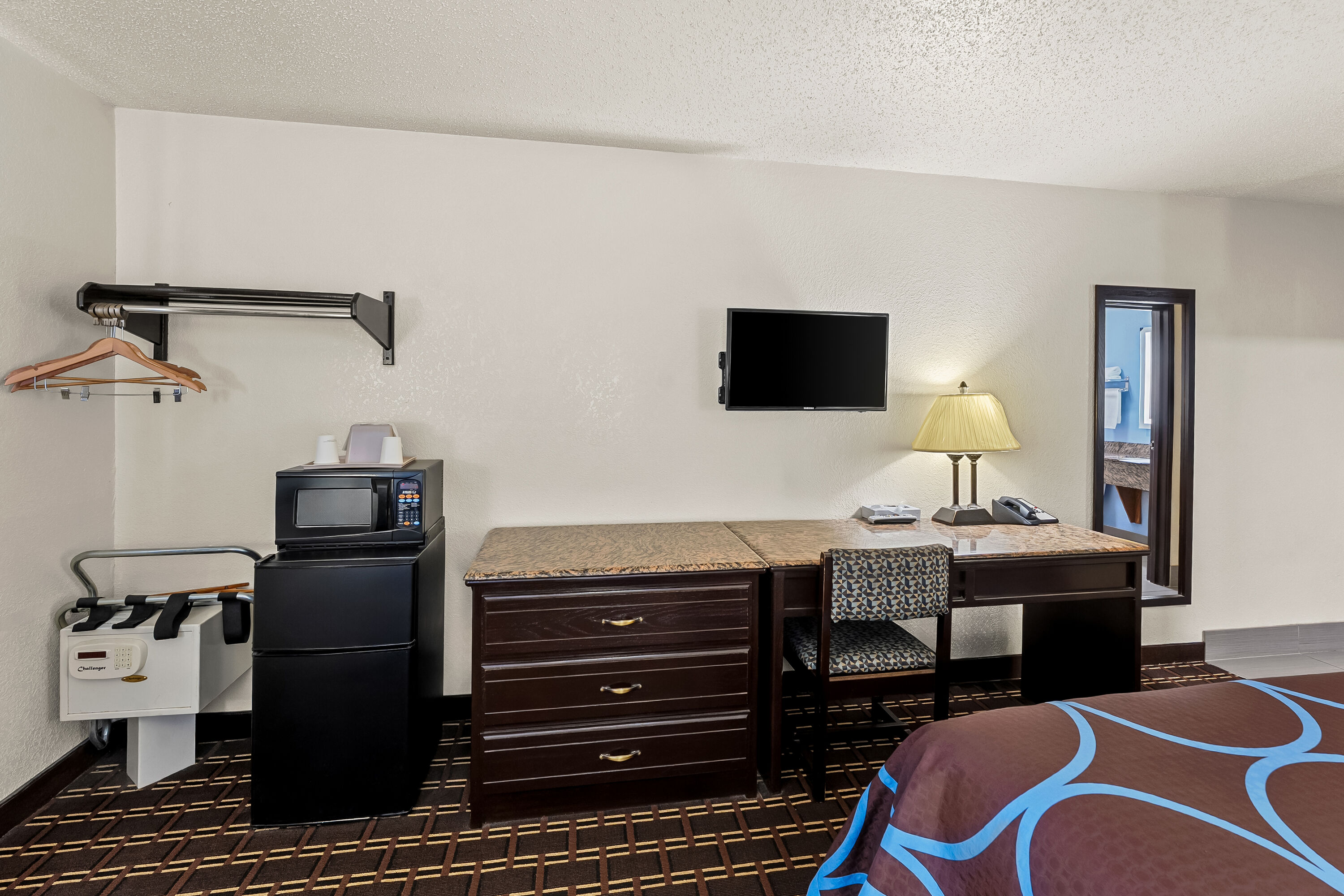 Queen bed guest room at the Super 8 by Wyndham New Castle in New Castle, Delaware