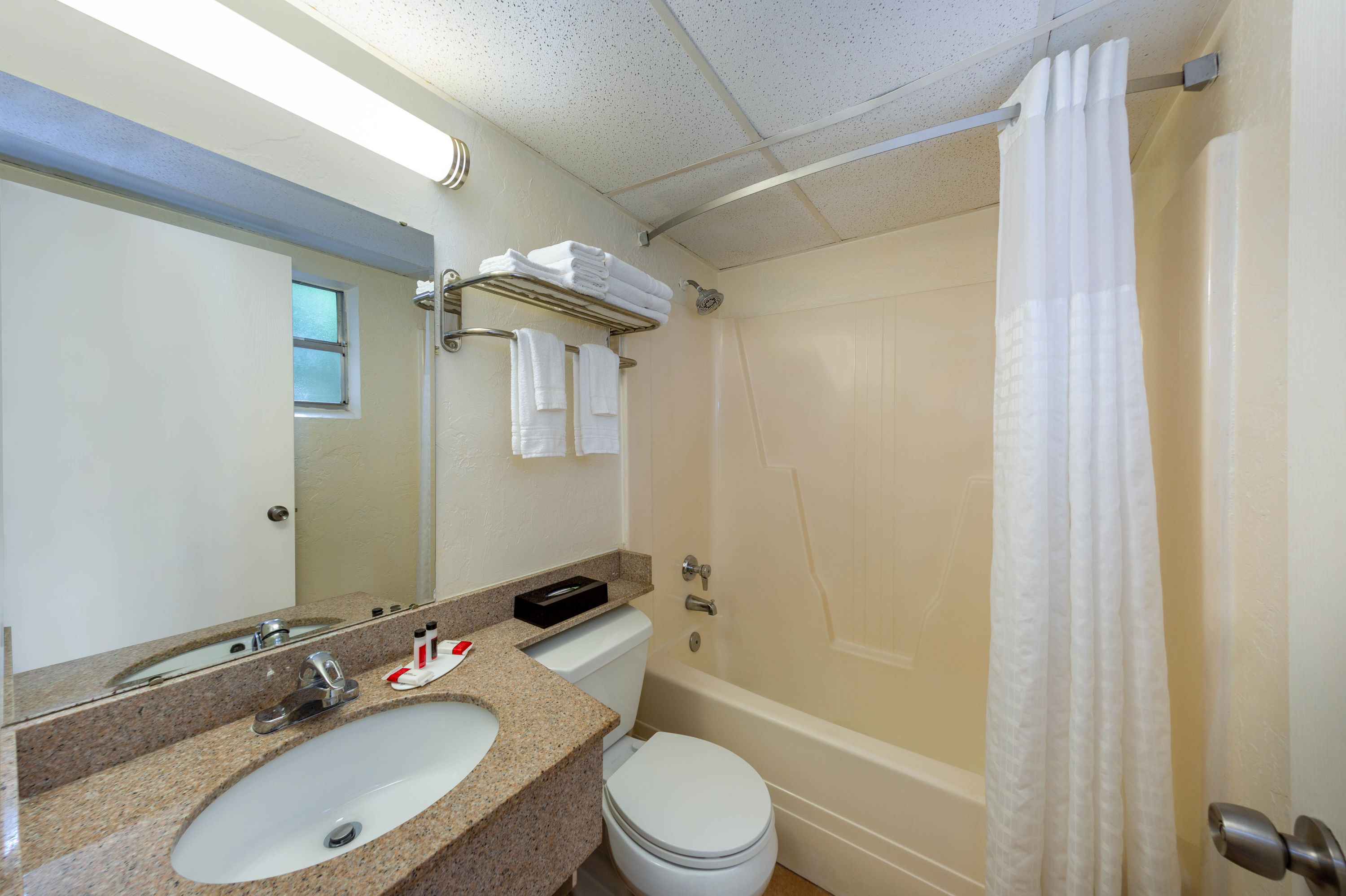 Guest room bath at the Super 8 by Wyndham Bradenton Sarasota Area in Bradenton, Florida