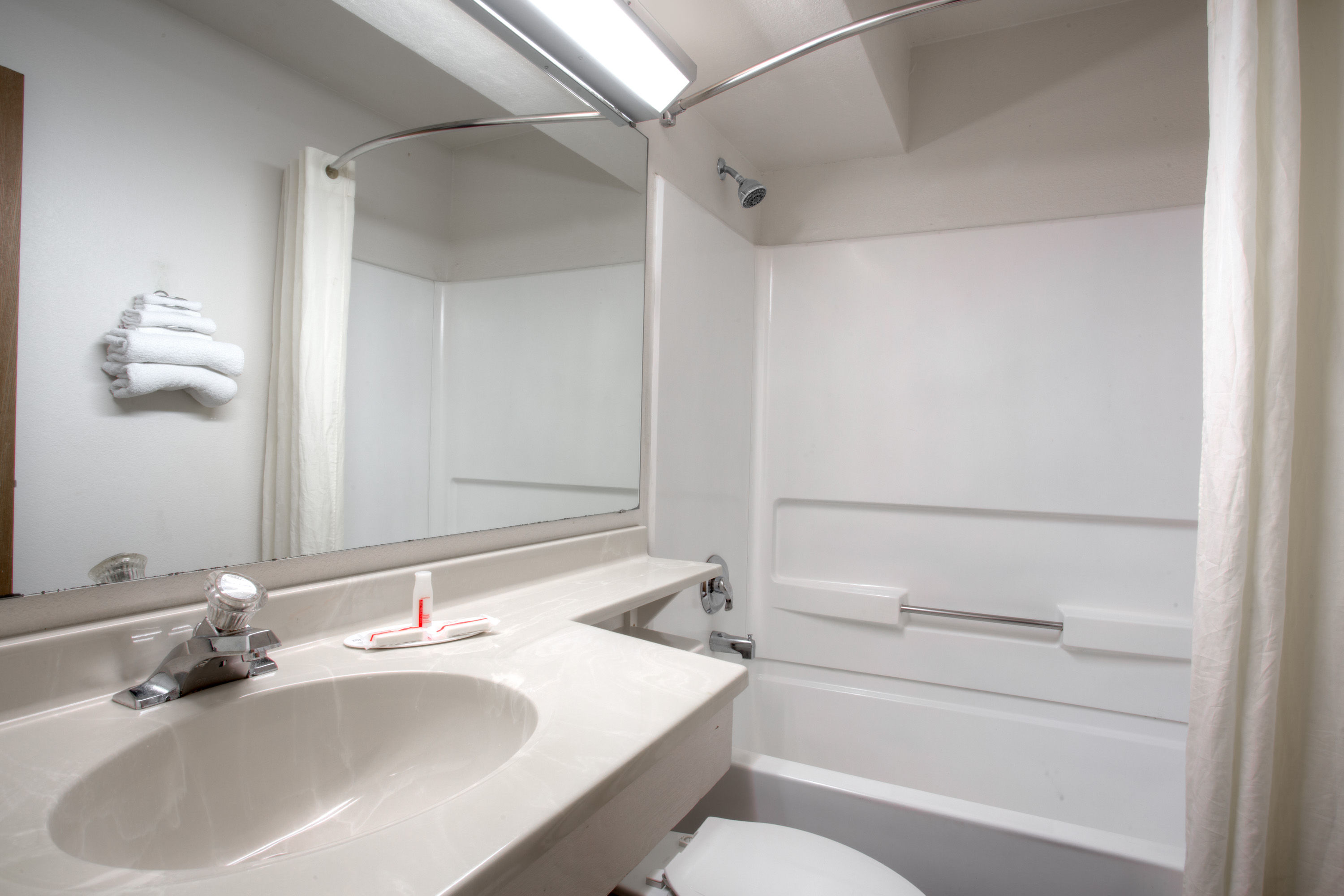 Guest room bath at the Super 8 by Wyndham Gainesville I-75 Hospital/University Area in Gainesville, Florida