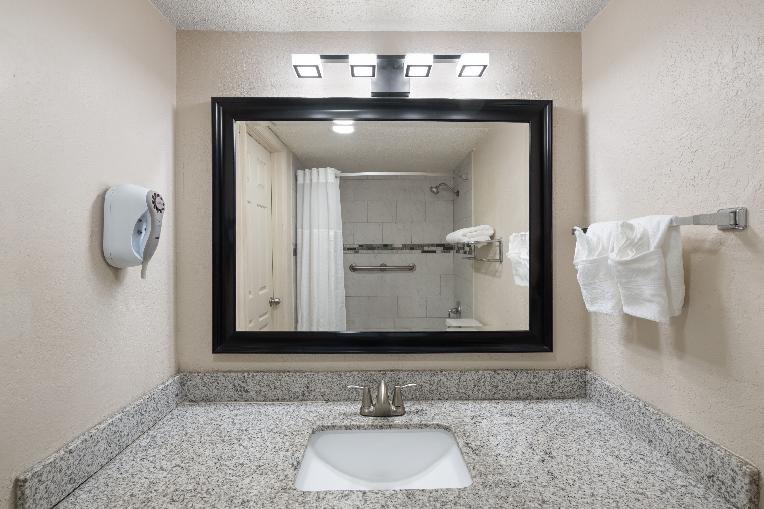 Guest room bath at the Super 8 by Wyndham Lake City in Lake City, Florida