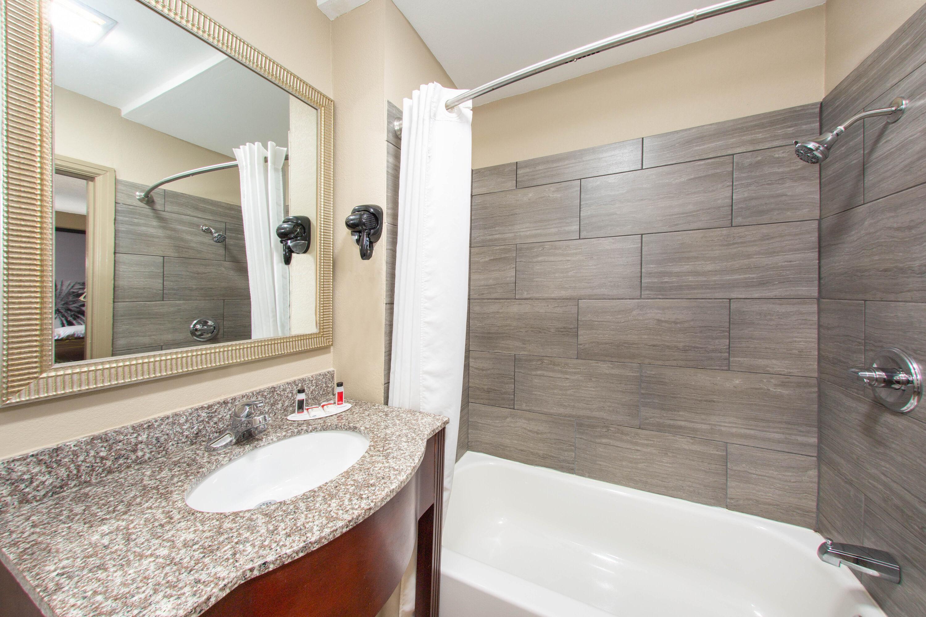 Guest room bath at the Super 8 by Wyndham Pensacola NAS Area in Pensacola, Florida