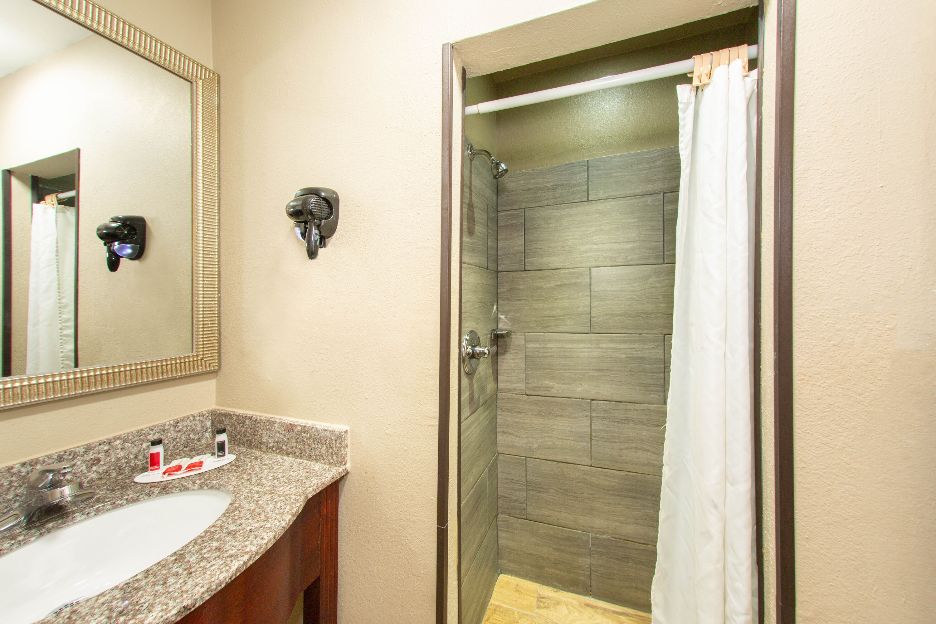 Guest room bath at the Super 8 by Wyndham Pensacola NAS Area in Pensacola, Florida