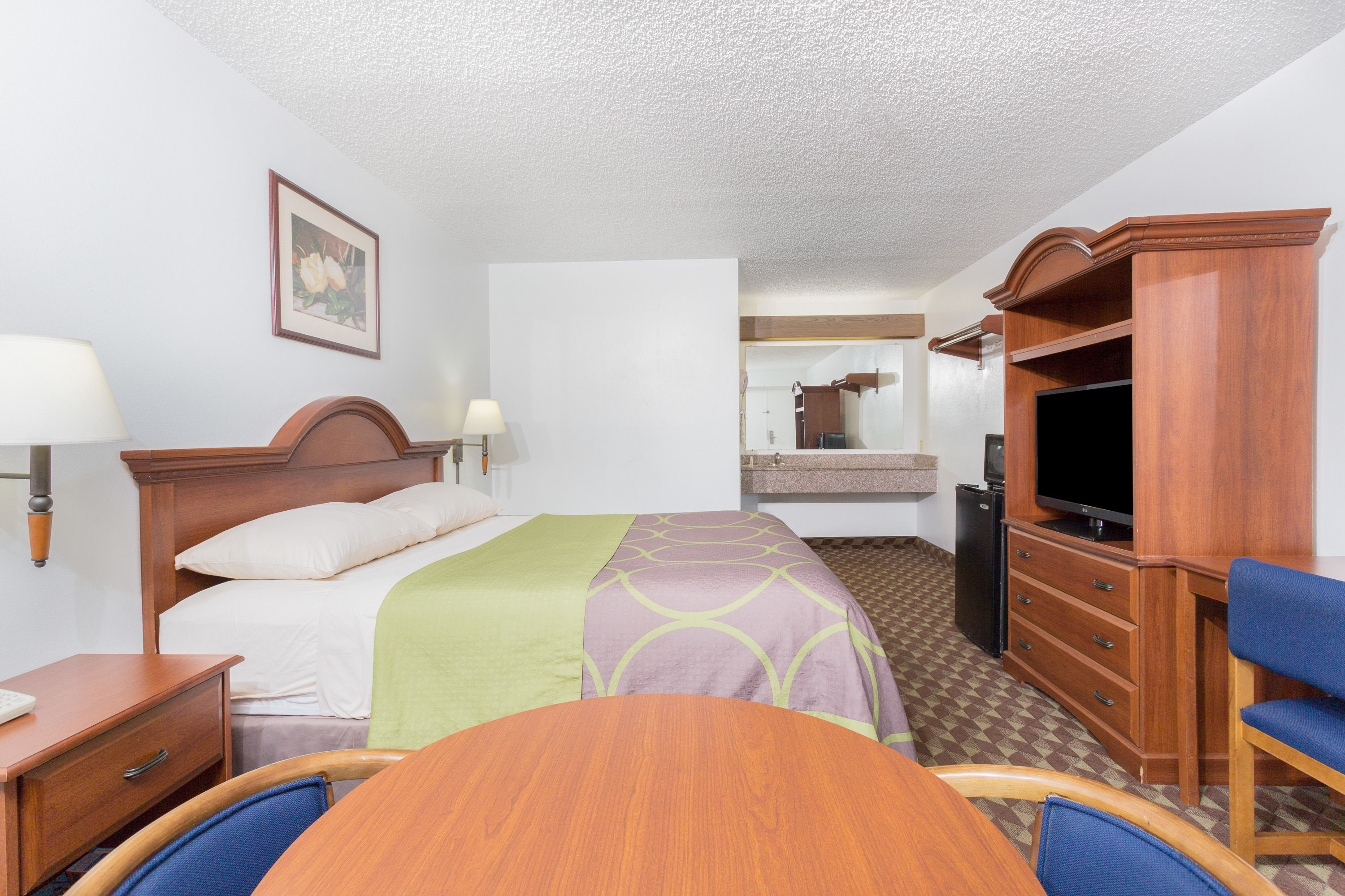 Guest room at the Super 8 by Wyndham Riviera Beach West Palm Beach in Riviera Beach, Florida