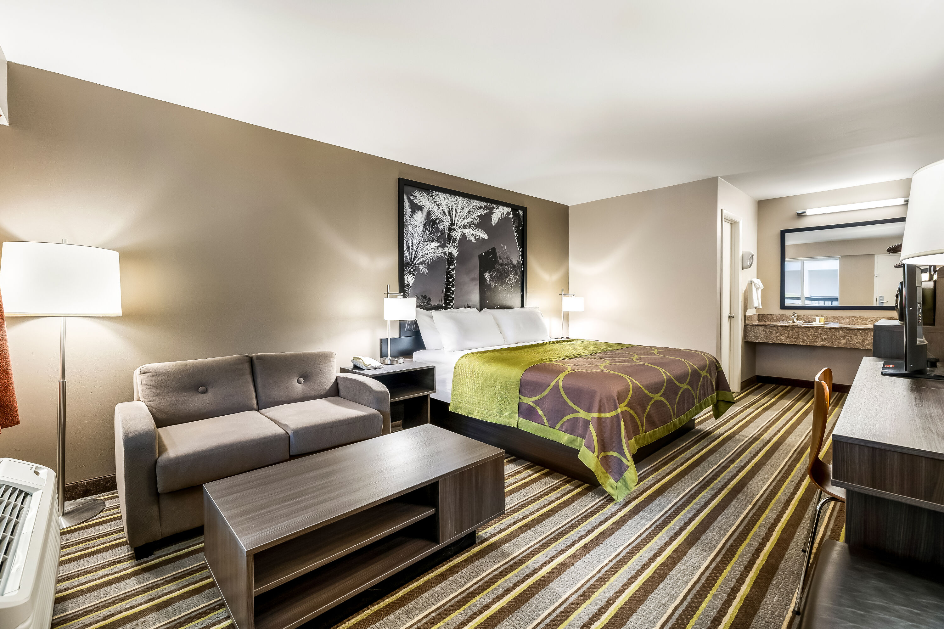 King bed guest room at the Super 8 by Wyndham Riviera Beach West Palm Beach in Riviera Beach, Florida