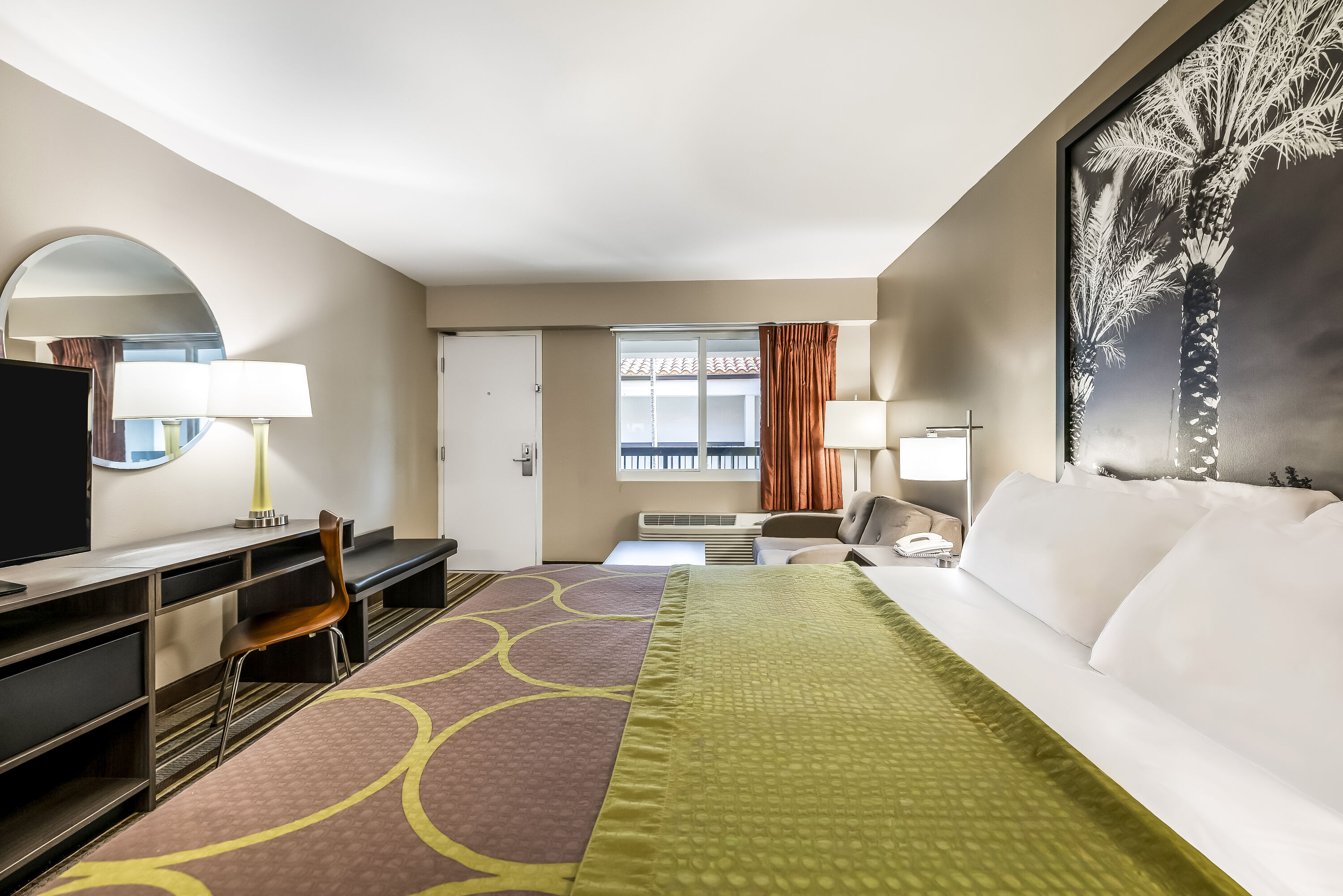King bed guest room at the Super 8 by Wyndham Riviera Beach West Palm Beach in Riviera Beach, Florida