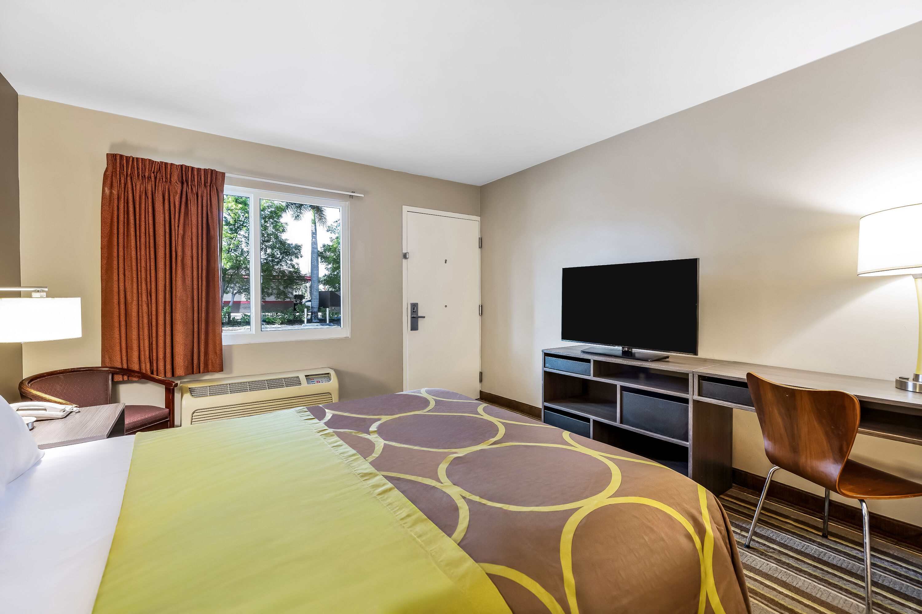 Queen bed guest room at the Super 8 by Wyndham Riviera Beach West Palm Beach in Riviera Beach, Florida