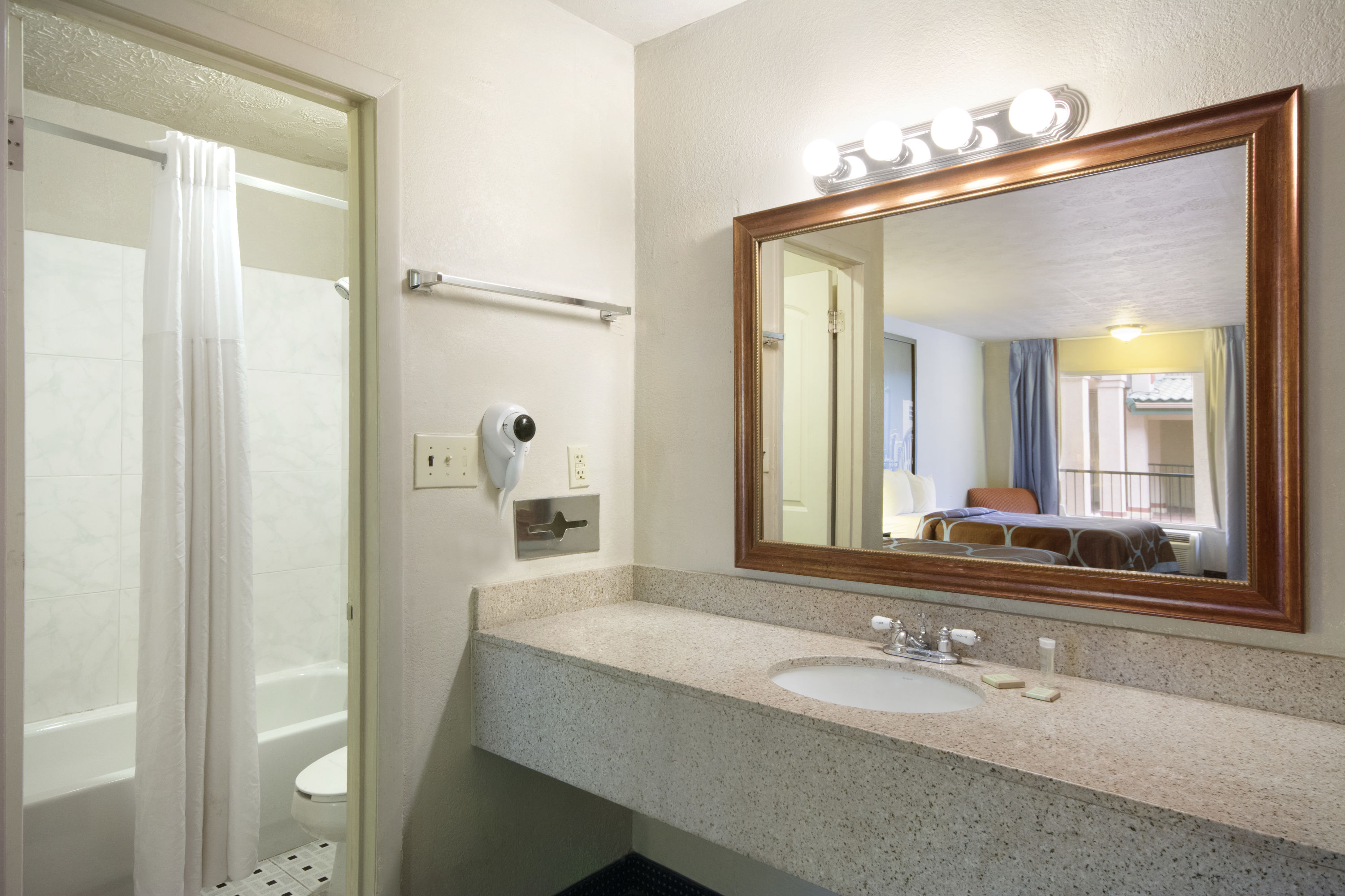 Guest room bath at the Super 8 by Wyndham Atlanta/Hartsfield Jackson Airport in College Park, Georgia