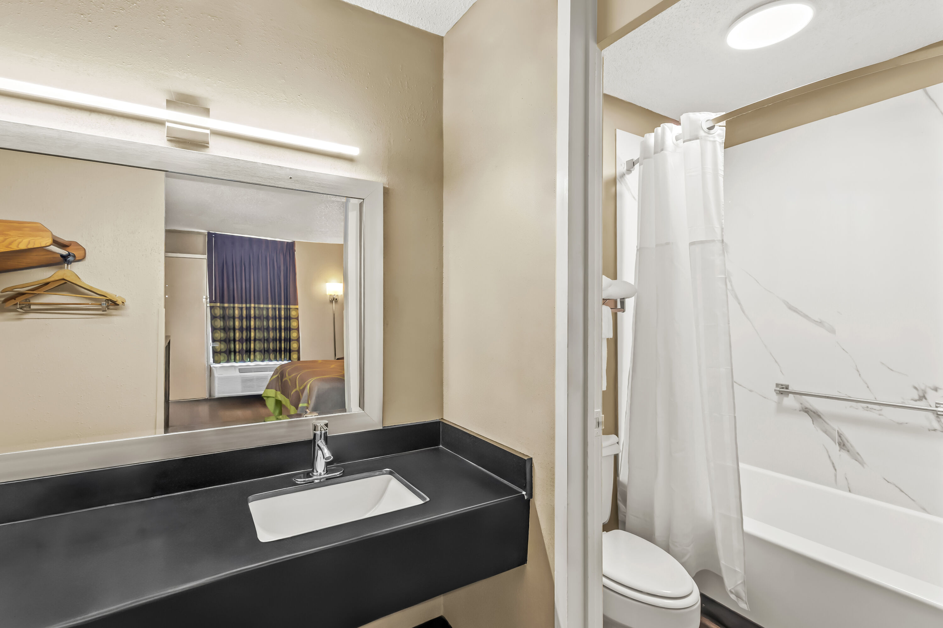 Guest room bath at the Super 8 by Wyndham Commerce in Commerce, Georgia